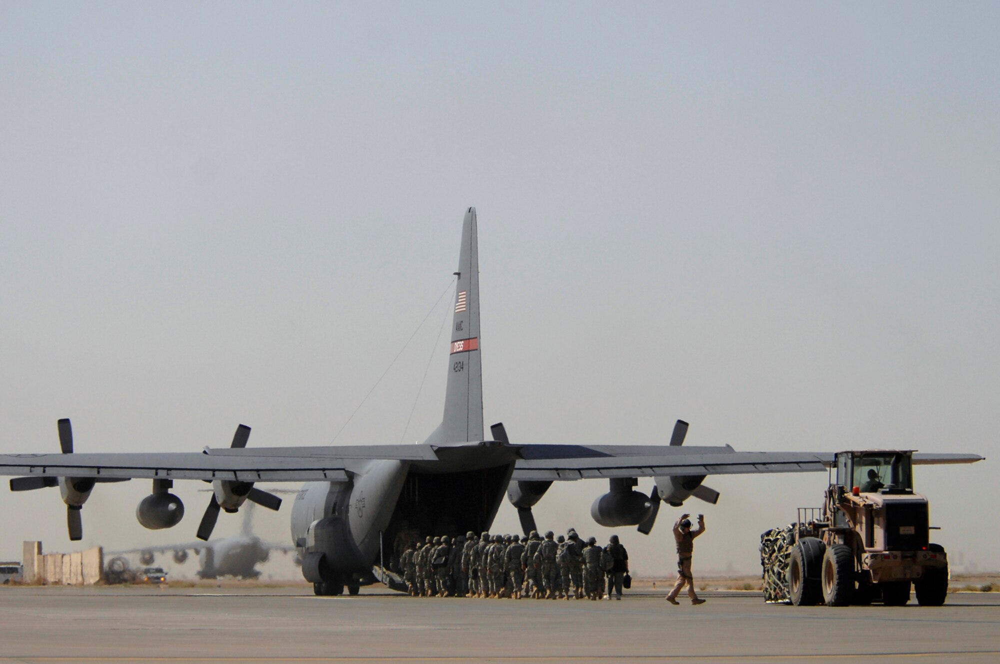 JOINT BASE BALAD, Iraq -- Servicemembers and cargo are loaded onto a C-130 Hercules from Dyess Air Force Base, Texas, here, June 18. The Air Force servicemembers are redeploying home following successful four- and six-month deployments. Personnel are continuously rotating into and out of the base, which is a hub for intra- and inter-theater traffic. The flexible design of the Hercules enables it to be rapidly configured for many different missions, including cargo and personnel movement. (U.S. Air Force photo/ Senior Airman Julianne Showalter)