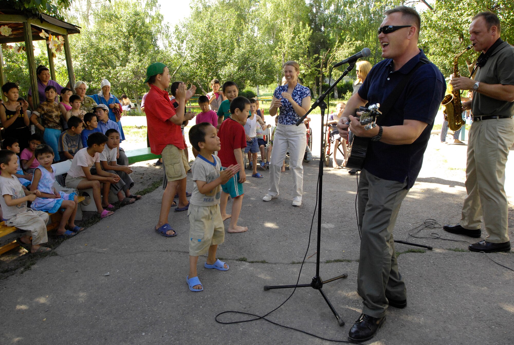 (08/06/14) The U.S. Air Forces Central Band Falcon, performs for the children of the Belovodosky Orphanage, Kyrgyz Republic today.  After AFCENT band performed at the orphanage, the children returned the favor by singing some of their favorite Russian military songs for the band.  (U.S. Air Force by Staff Sgt. Tabitha Kuykendall/ Released)
