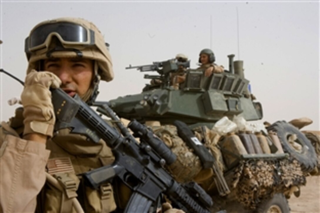 U.S. Marine Sgt. Daniel Leach  talks to fellow Marines via radio during Operation Defeat al-Qaeda in the North, in the Northern Al Anbar Province, Iraq, June 11, 2008. Leach is assigned to the  Multi National Force-West Ground Combat Element's Company D, 2nd Light Armored Reconnaissance Battalion, Task Force Mech.