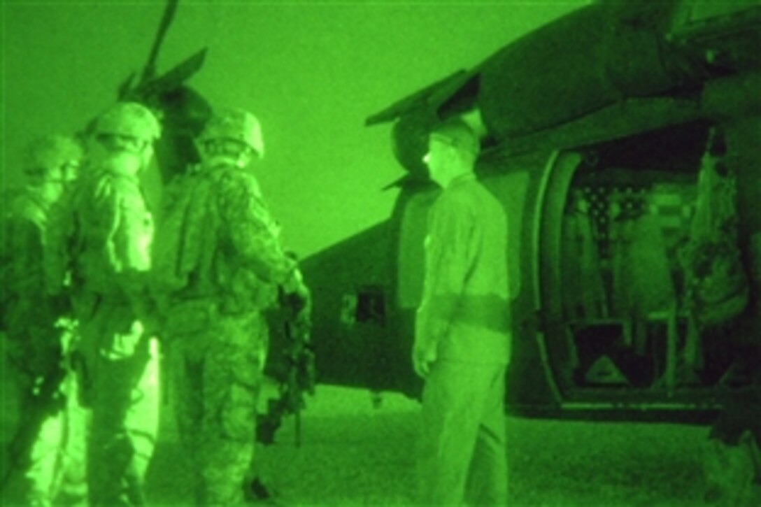 U.S. Army soldiers prepare to board a UH-60 helicopter to conduct an air assault mission on Forward Operating Base Iskan, Iraq, June 12, 2008. The soldiers are assigned to the 7th Infantry Regiment's 3rd Battalion.