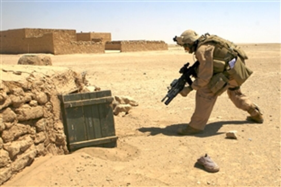 U.S. Marine Sgt. Michael J. Beaver cautiously approaches a chicken coup during a mission in a village near the northern Anbar province in Iraw, June 13, 2008. Beaver is assigned to  Headquarters Company, 2nd Light Armored Reconnaissance Regiment.
