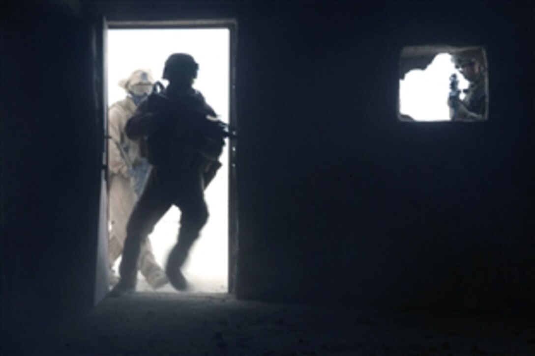 U.S. Marines clear an abandoned house during Operation Defeat Al Qaida in northern Al Anbar province, Iraq, June 11, 2008. The Marines are assigned to Delta Company, 2nd Light Armored Reconnaissance Battalion, Multinational Force-West Ground Combat Element.

