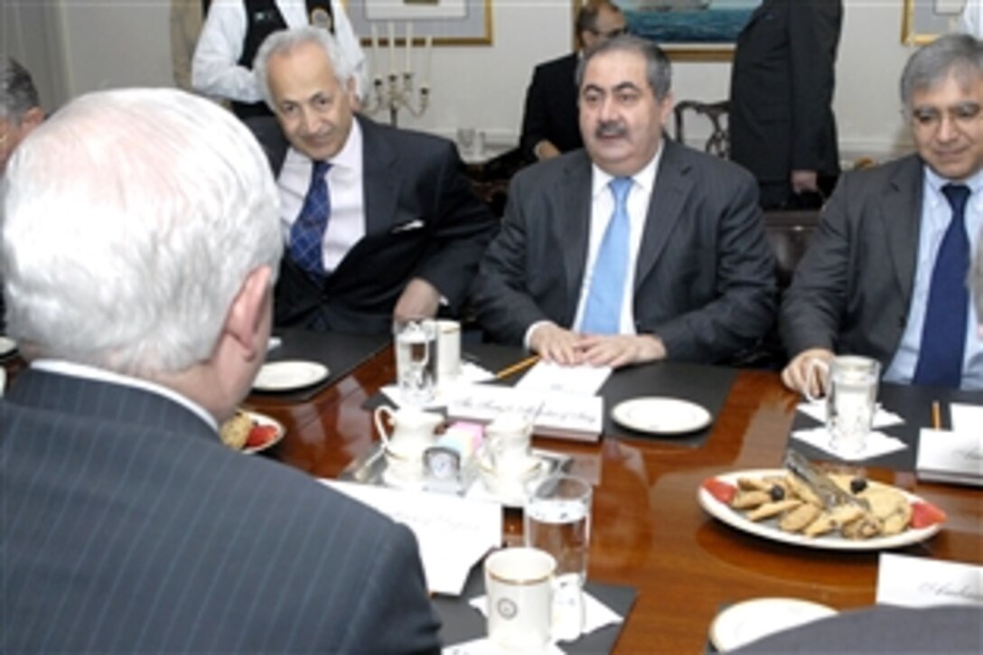 U.S. Defense Secretary Robert M. Gates, forground, talks with Iraqi Foreign Minister Hoshyar Zebari, middle background, during a meeting inside the Pentagon, June 18, 2008.  