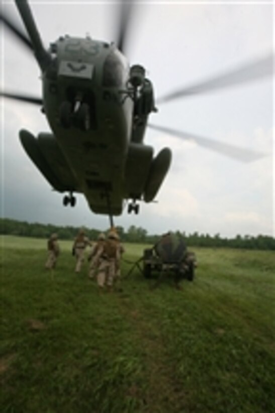 U.S. Marines assigned to Combat Logistics Battalion 26, 26th Marine Expeditionary Unit attach a water bull to a CH-53E Super Stallion helicopter at Camp Atterbury, Ind., on June 13, 2008.  The service members are conducting realistic urban training exercises to prepare for deployments later in the year.  
