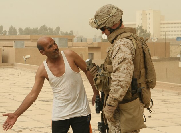 A citizen of Ramadi points out structural damage on the roof of a boys and girls school to Staff Sgt. Earl Lucas, a platoon sergeant with Regimental Combat Team 1, June 18. Repairing the schools in Ramadi has been a key effort in the rebuilding stage. A number of schools in the city are in need of renovations due to structural damage and leaky roofs. "(Repairing the schools is essential because) it's a school, it's their future," said Cpl. Chris Sarlo, a squad automatic weapon gunner with Weapons Company. "The children coming up now grew up around violence and fighting. Now that the fighting is over with, we need to focus on their education and hopefully make everything better in the region."