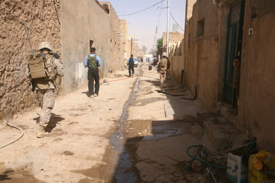 Marines with 3rd Battalion, 14th Marine Regiment, 2nd Light Armored Reconnaissance Battalion, Regimental Combat Team 5, and Iraqi Police conduct a joint patrol though the streets of Rutbah, Iraq, June 28.  The members of the battery have been conducting consolidated patrols with the IP of Rutbah to improve the policemenâ??s skill at conducting patrols.