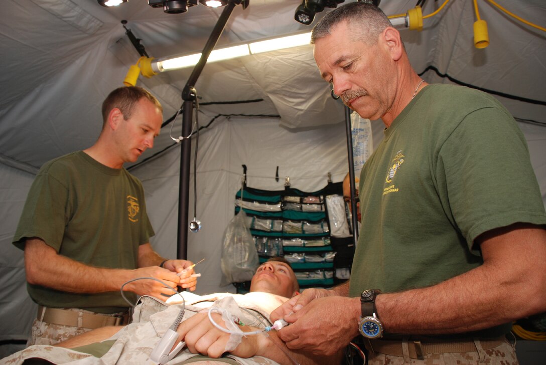 Lt. Cmdr. Winston Centro, perioperative nurse and Plano, Texas resident with 4th Medical Battalion, 4th Marine Logistics Group, prepares Staff Sgt. Travis Allen, platoon sergeant and Dallas resident with javelin platoon, Weapons Company, 1st Battalion, 23rd Marine Regiment, for a cyst removal procedure. Centro is a member of the Forward Resuscitative Surgical System team, a highly mobile shock trauma system that provides a level-two medical capability in field environments. The FRSS team recently supported 1st Battalion, 23rd Marines during exercise African Lion 08 a combined arms, bi-lateral training exercise between U.S. and Moroccan forces in Morocco.