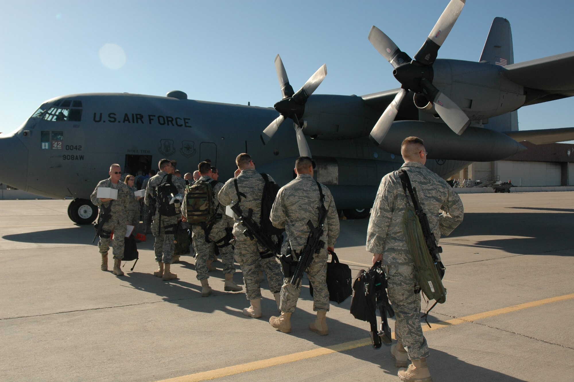 Reservists with the 944th Security Forces Squadron load onto a C-130 June 11 at Luke Air Force Base, Ariz. The security forces team will undergo training and will deploy to Iraq for six months. (U.S. Air Force photo/Tech. Sgt. Susan Stout)