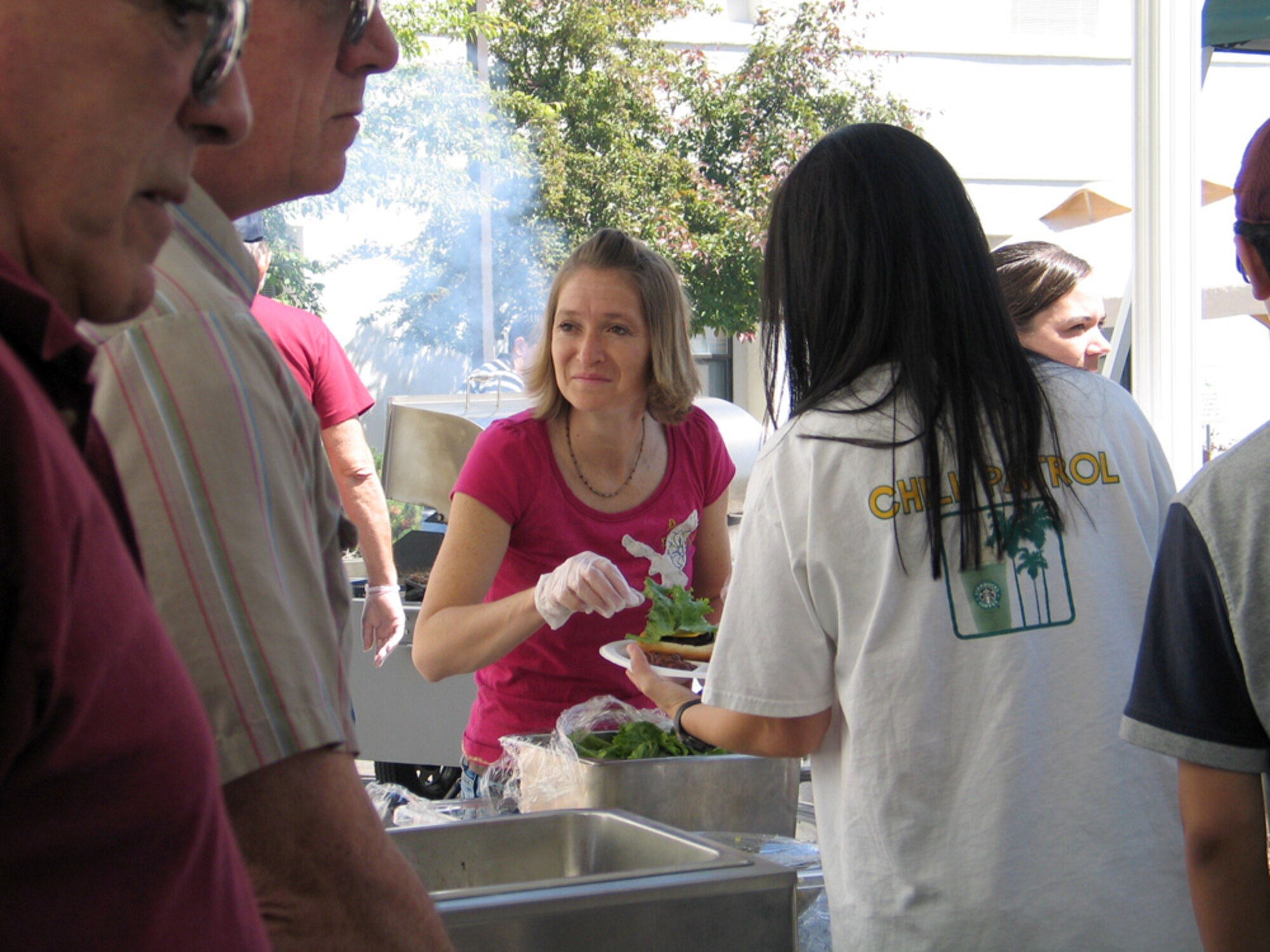 FAIRCHILD AIR FORCE BASE, Wash. – Tech. Sgt. Katie Stoner, 92nd Medical Support Squadron, serves barbeque food to residents of the Spokane Veterans Home June 14. Members of the Fairchild 5/6 Club, along with their families, volunteered to serve food, and set up and tear down equipment, during the home’s Father’s Day barbeque. Veterans Home residents’ family and friends were invited to the event, and more than 250 people attended. (U.S. Air Force photo / Staff Sgt. Connie L. Bias)