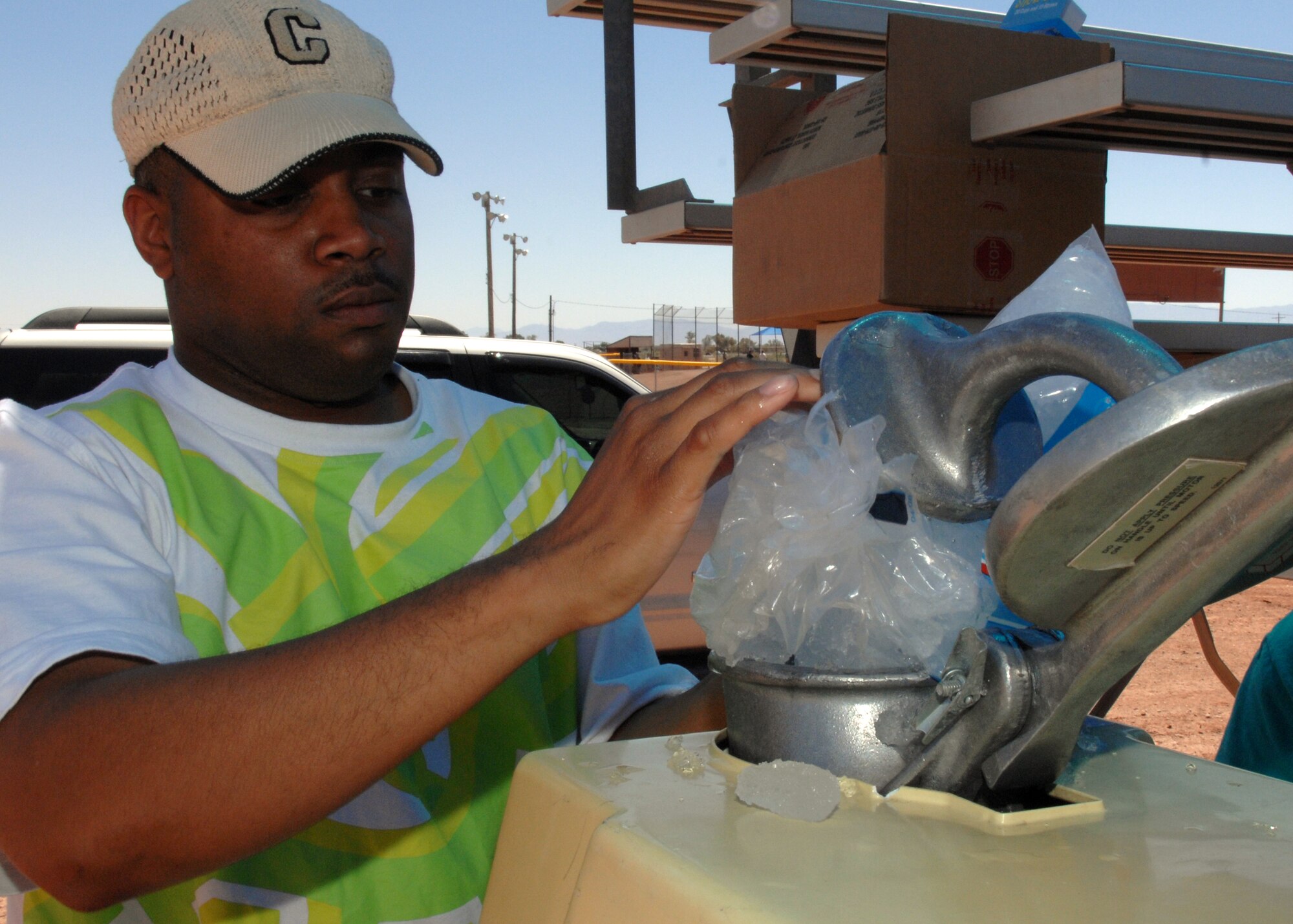 Staff Sgt. William Curtis Jr, puts ice into the snow-cone maker before the 46th Test Group's Charity Softball Game June 12 on Holloman Air Force Base, N.M. Sergeant Curtis is an aviation resource manager assigned to the 586th Flight Test Squadron. The charity game was in conjunction with their sports day. The 46th Test Group military and civilians raised money for a local non- profit organization in the Alamogordo community.
(U.S. Air Force photo/Senior Airman Anthony Nelson Jr)
