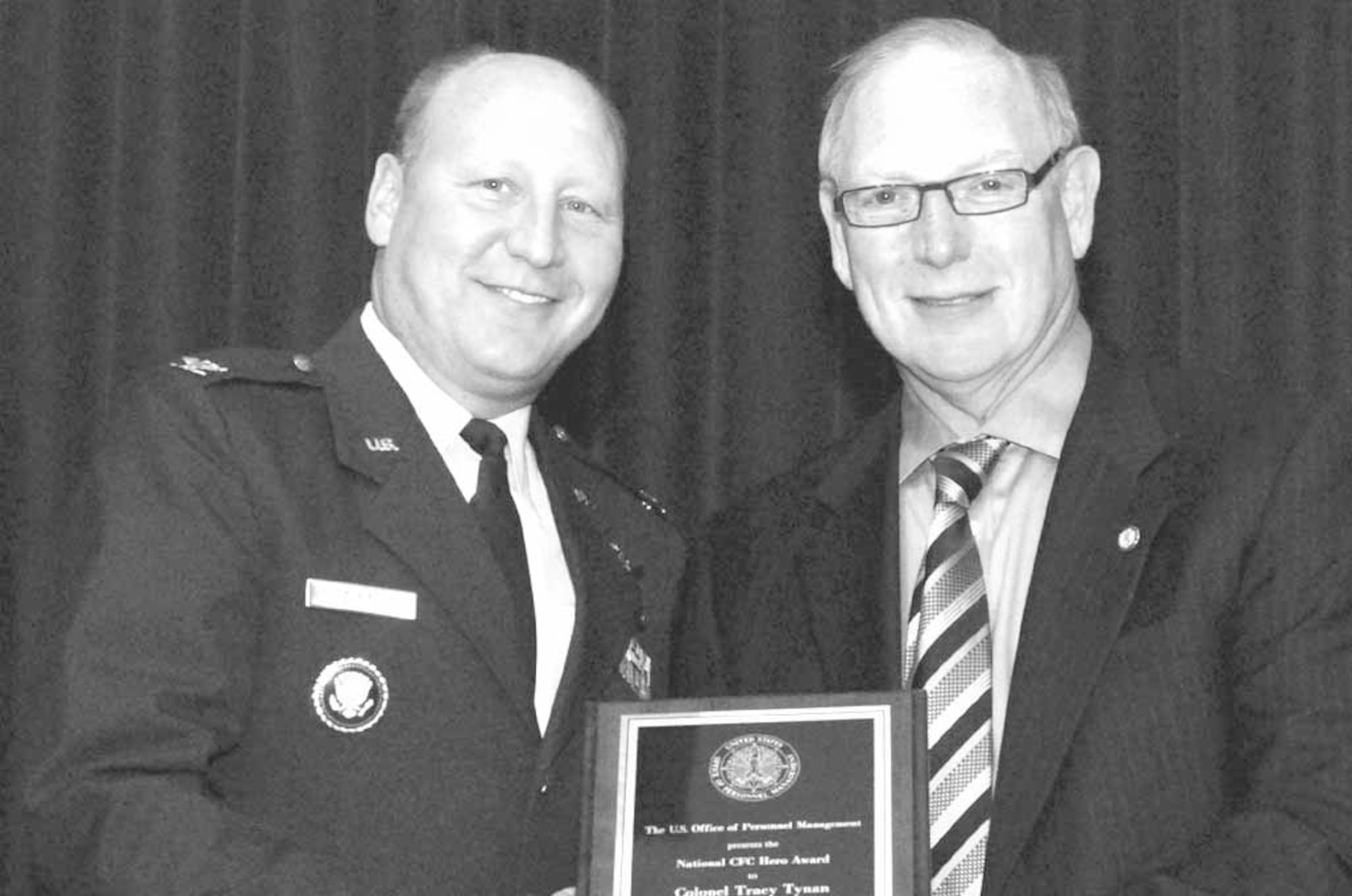 Col. Tracy Tynan, Tinker Combined Federal Campaign coordinator, receives the 2007 CFC Hero Award from Office of Personnel Management Deputy Director Howard Weizmann.  (Air Force photo by Margo Wrigjt)