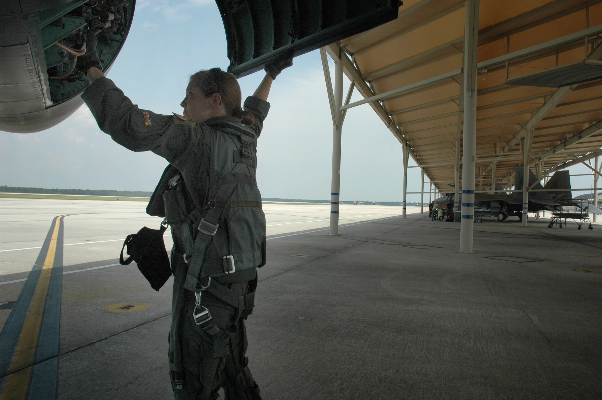 TYNDALL AIR FORCE BASE, Fla. - Captain Jaina Wright, 336th Fighter Squadron F-15E Strike Eagle pilot, conducts a pre-flight inspection before executing a dissimilar air combat tactics sortie against F-22 Raptor aircraft at Tyndall Air Force Base June 18. Captain Wright and fellow Strike Eagle aircrew members conducted DACT training at Tyndall AFB June 16-20. (U.S. Air Force photo by Capt. Amanda Ferrell)