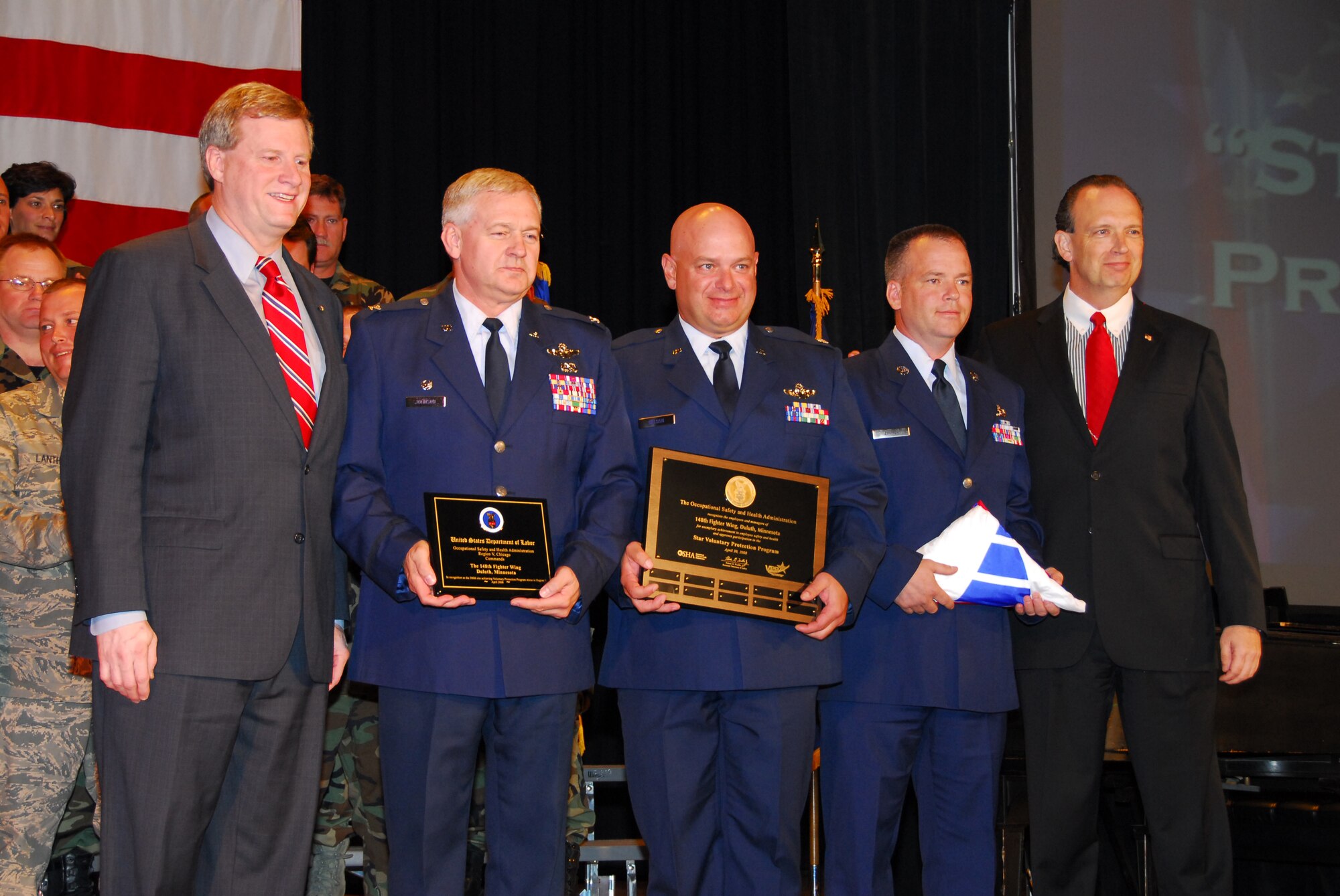 The Honorable William C. Anderson (far right), Assistant Secretary of the Air Force and the Honorable Edwin G. Foulke (far left), Assistant Secretary of Labor for Occupational Safety and Health present the 148th Fighter Wing, Duluth, Minn. with OSHA's Voluntary Protection Program STAR rating at an awards ceremony in Duluth, Minn. on June 15, 2008.  The 148th is the first Air Force unit to receive OSHA's Voluntary Protection Program STAR rating. (U.S. Air Force photo by Tech. Sgt. Brett R. Ewald)  (Released)

