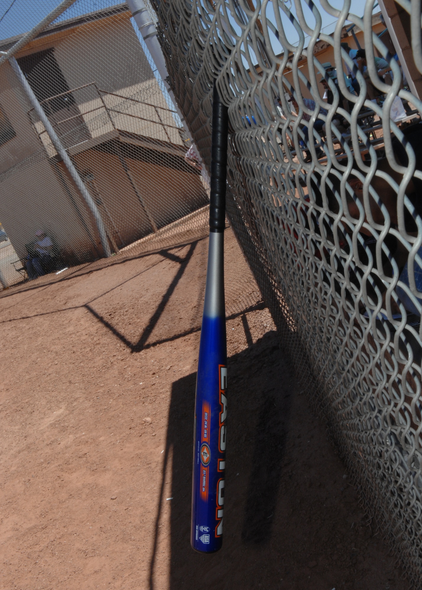 A bat hangs on the fence of the 586th Flight Test Squadron's dugout during the 46th Test Group's Charity Softball Game June 12 on Holloman Air Force Base, N.M. The 46th Test Group's military and civilians raised money for an organization in the Alamogordo community.

(U.S. Air Force photo/Senior Airman Anthony Nelson Jr)
