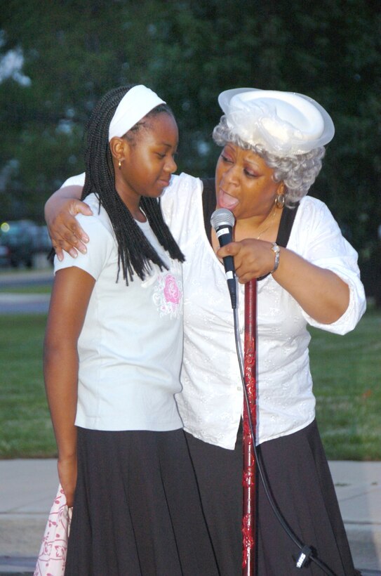 ANDREWS AIR FORCE BASE, Md. -- Alicia Patterson portrays an elderly woman, giving guidance to Christine Washington, 12, in dealing with the hardships of slavery prior to their emancipation. Juneteenth, also known as Emancipation Day or Freedom Day, is the oldest known celebration commemorating the ending of slavery in the United States, dating back to June 19, 1865. (U.S. Air Force photo by Bobby Jones)