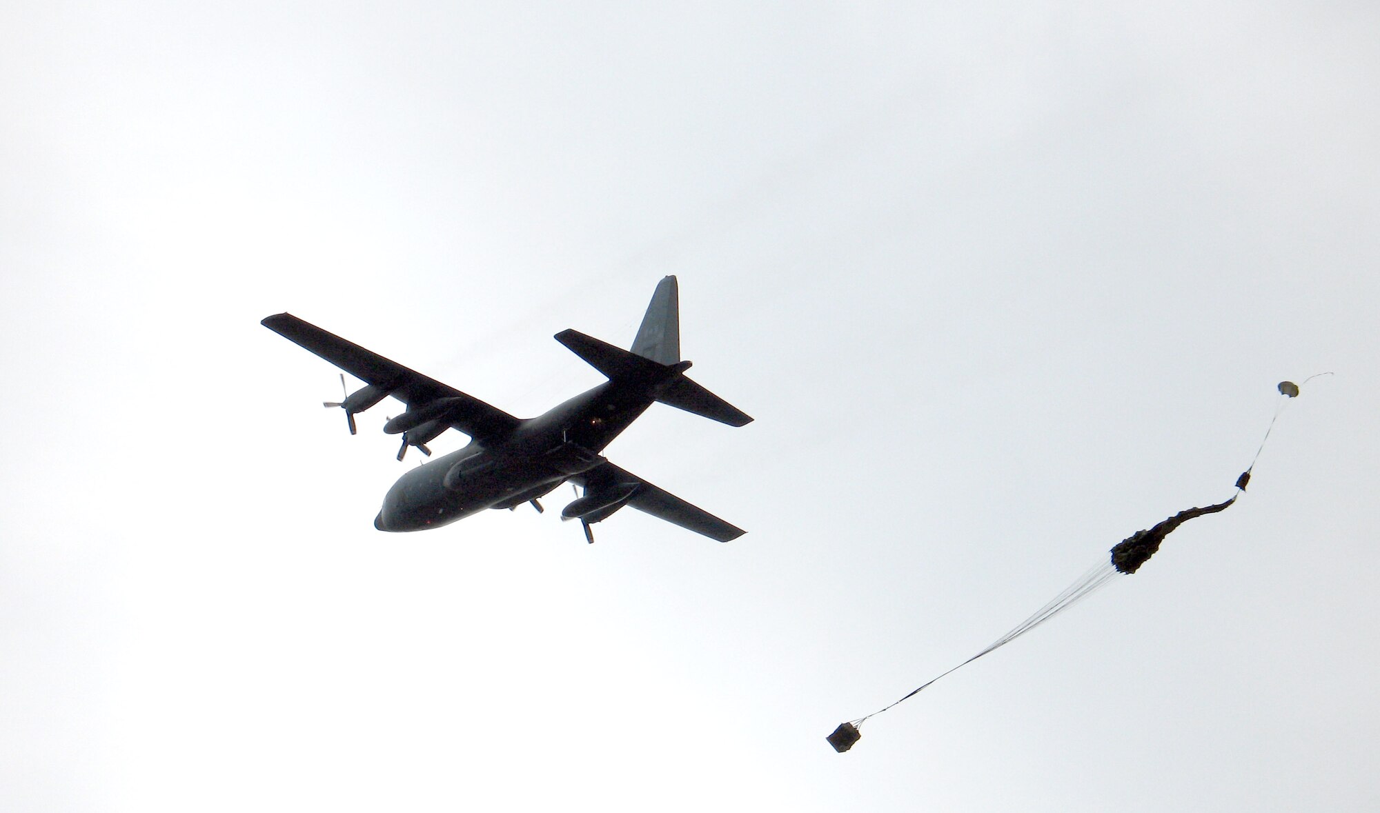 A C-130 Hercules conducts a precision air drop for a NATO-sponsored Precision Airdrop Capabilities demonstration at the Centre d'Essais Lancement de Missiles at Biscarrosee and at Cazaux Air Base, France. The C-130 and its crew were from Ramstein AB, Germany. (U.S. Air Force photo)