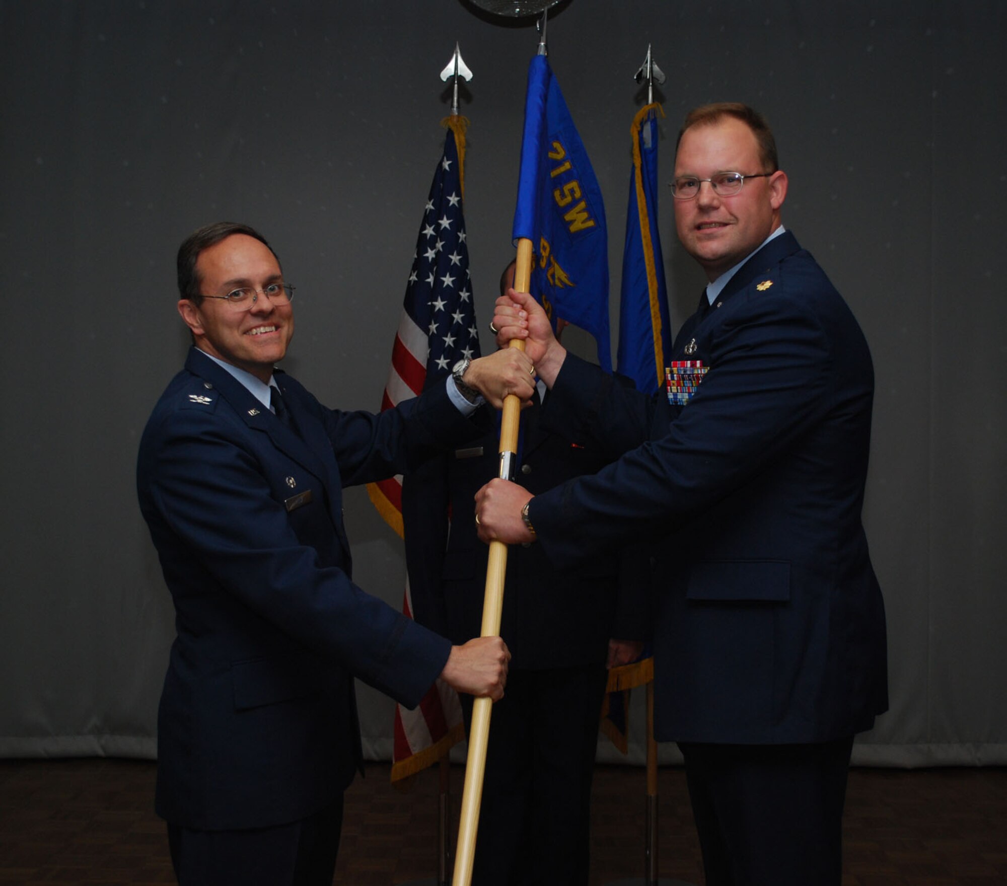 THULE AIR BASE, Greenland – Maj. Dayton Nooner receives the 821st Support Squadron guidon from Col. Lee-Volker Cox, 821st Air Base Group commander, as he assumes command during the squadron’s change-of-command ceremony June 19 at the Top of the World Club here. As support squadron commander for Thule Air Base, Major Nooner leads more than 40 military and civilian personnel providing all civil engineering, services, communications, information management, and medical support to Ballistic Missile Early Warning System radar; Detachment 3, 22nd Space Operations Squadron; and international military and scientific arctic operations. (U.S. Air Force photo/1st Lt. Nicole Langley)