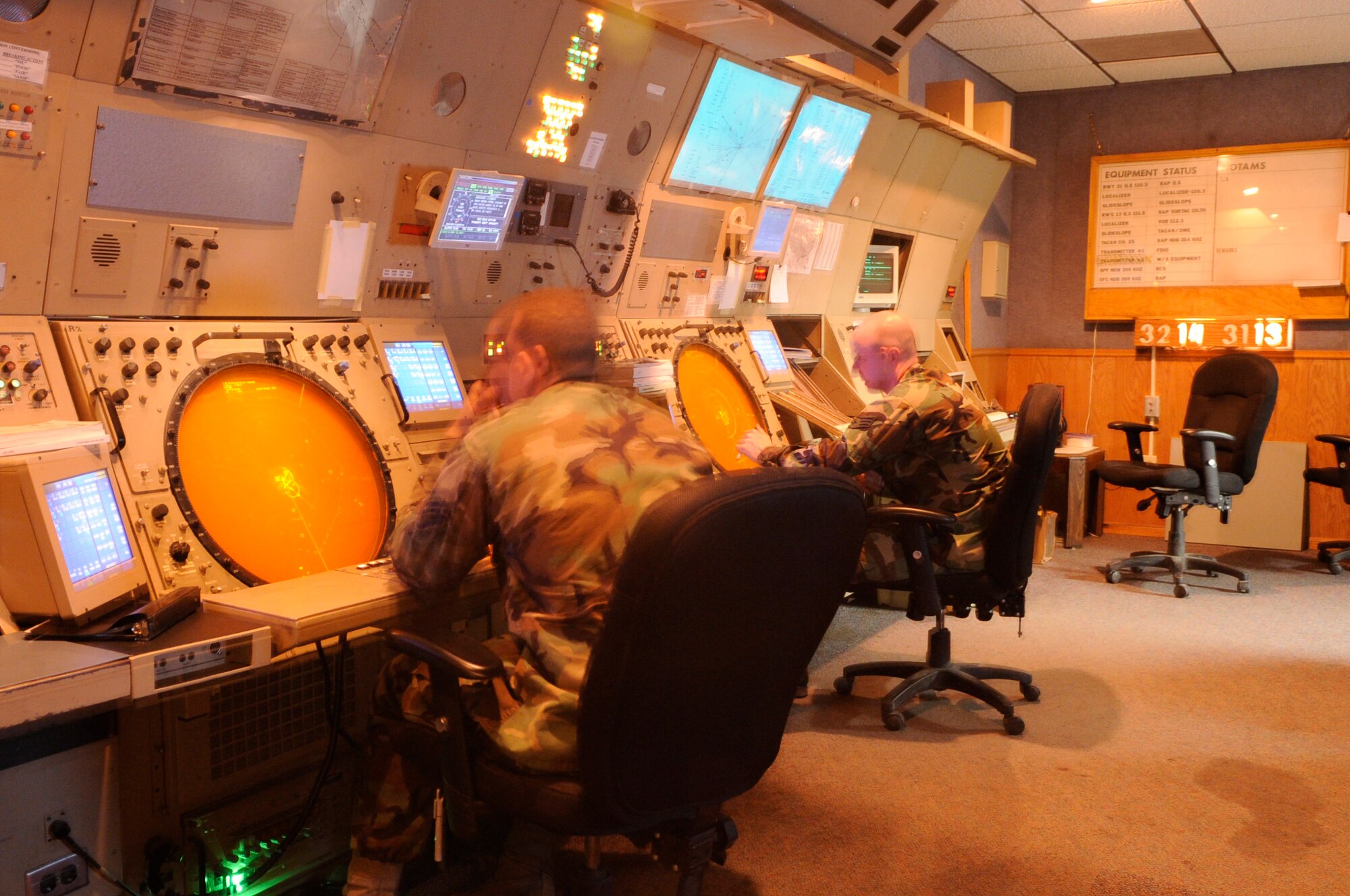 Staff Sgt. Jacob Martin (left) and Senior Airman Scott Causey monitor the old Radar Approach Control system June 17 at Ellsworth Air Force Base, S.D. This RAPCON system will be updated with the new Standard Terminal Automation Replacement System June 30, saving the Air Force $28.7 million over the next 20 years. Sergeant Martin and Airman Causey are 28th Operations Support Squadron Air Traffic Control journeymen. (U.S. Air Force photo/Airman 1st Class Kasey Zickmund) 
