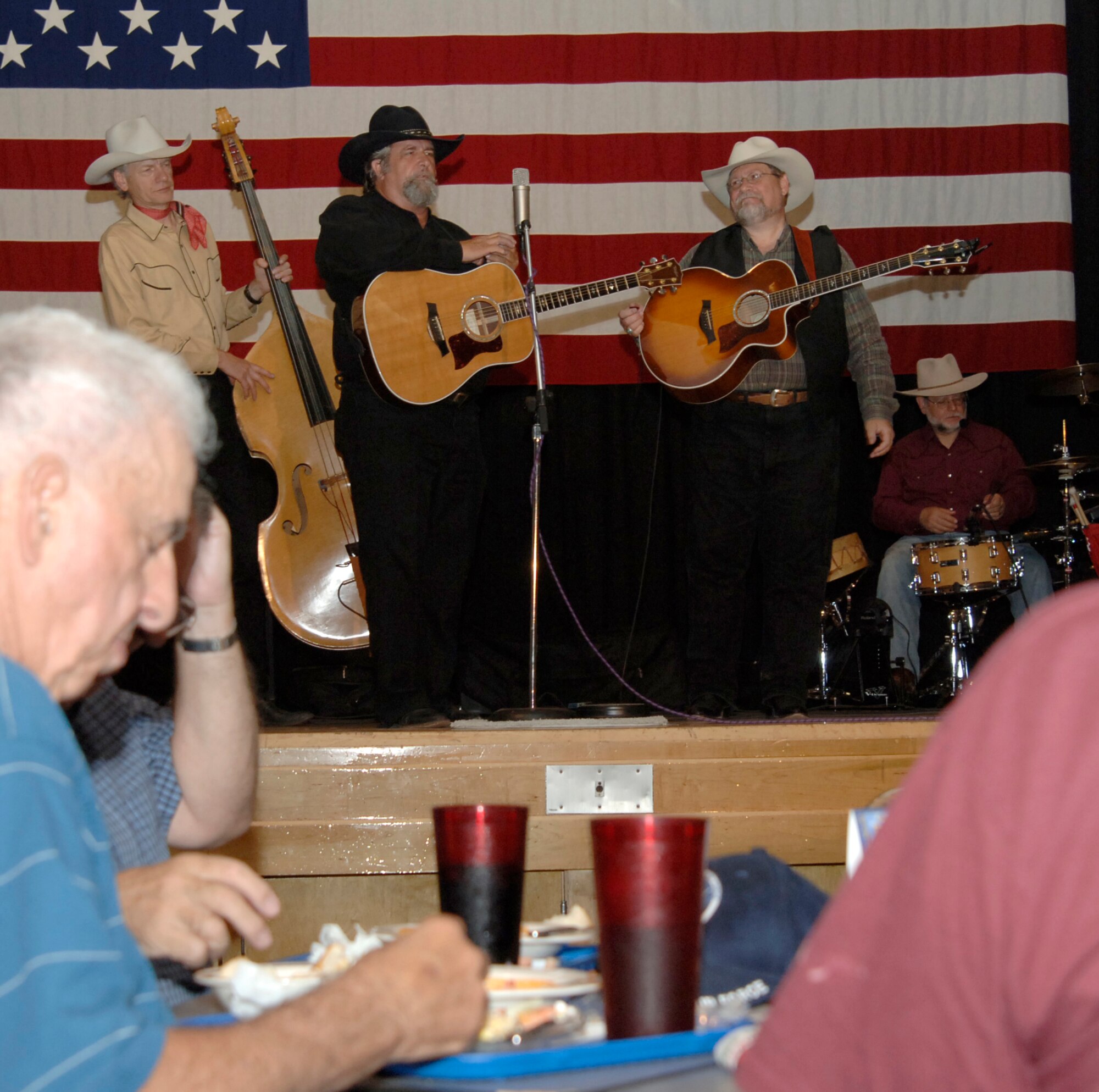 MCCONNELL AIR FORCE BASE, Kan. -- Diamond W. Wranglers plays cowboy trail songs for Team McConnell members and their families at the Robert J. Dole Community Center, June 18. The Diamond W. Wranglers are part of the Great American Cowboy Concert that plays around the world. Their first concert was on the Great Wall of China. (Photo by Senior Airman Roy Lynch III)