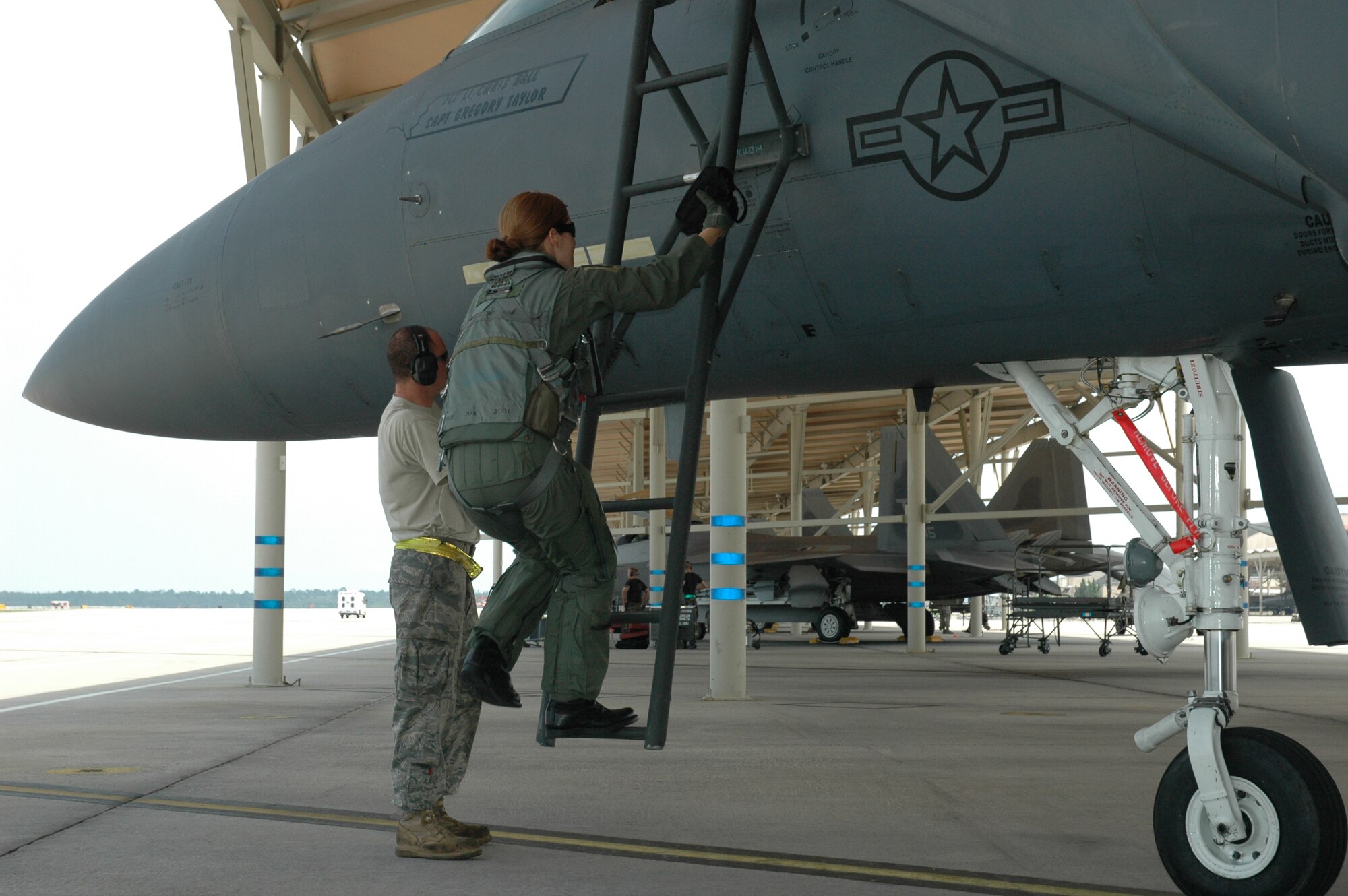 Capt. Jaina Wright, 336th Fighter Squadron F-15E Strike Eagle pilot, climbs into the cockpit as Senior Airman Matthew Jones, 4th Aircraft Maintenance Squadron dedicated crew chief, makes final mechanical adjustments prior to take off. Captain Wright and fellow members of the 333rd, 334th, 335th and 336th Fighter Squadrons arrived at Tyndall Air Force Base Monday to conduct dissimilar air combat tactics training missions with F-22 Raptor aircraft assigned to the 43rd Fighter Squadron at Tyndall. The Strike Eagle units will return to Seymour Johnson AFB June 20 after completing nearly 36 DACT sorties. 