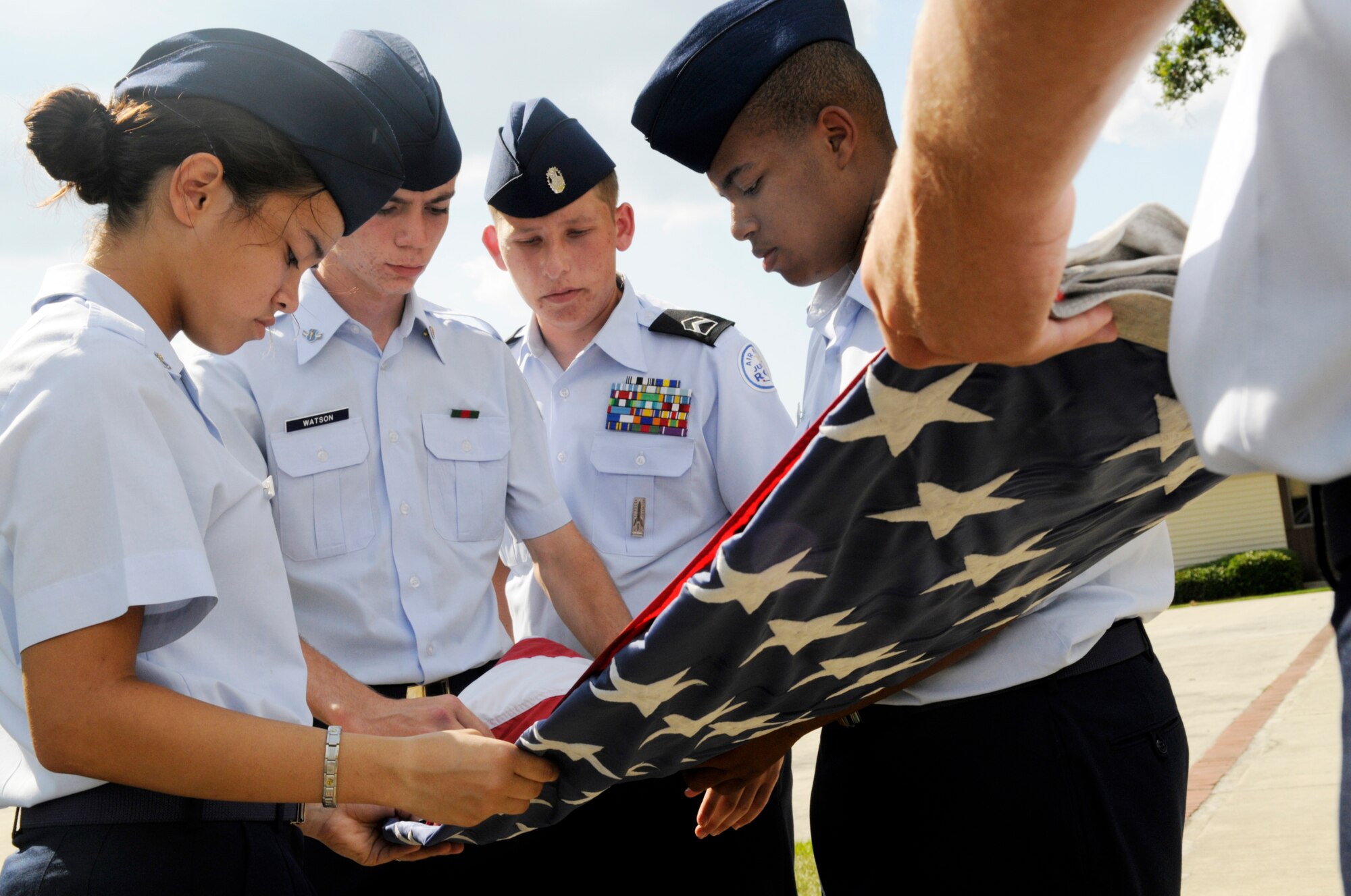 Cadets Felisa Glover, Michael Watson, Matthew Newell, and Tre' Barnes  fold the flag during retreat June 12. U. S. Air Force photo by Sue Sapp