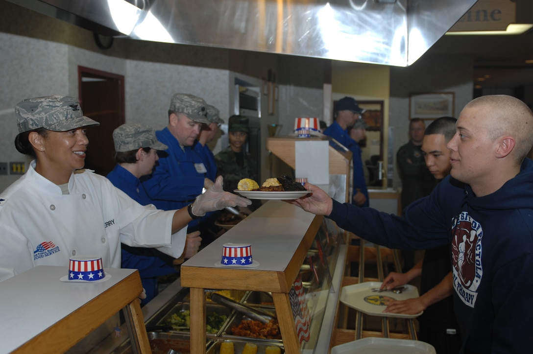 Col. Judy Perry, Air Force Financial Services Center commander, serves food to Airmen at the Ellsworth Air Force Base, S.D., Bandit Inn Dining Facility before the Airmen Appreciation Barbecue June 18, 2008. The Airmen Appreciation Barbecue was an opportunity for base leadership to thank Ellsworth Airmen for their service and hard work. (U.S. Air Force photo/Airman 1st Class Joshua Seybert)