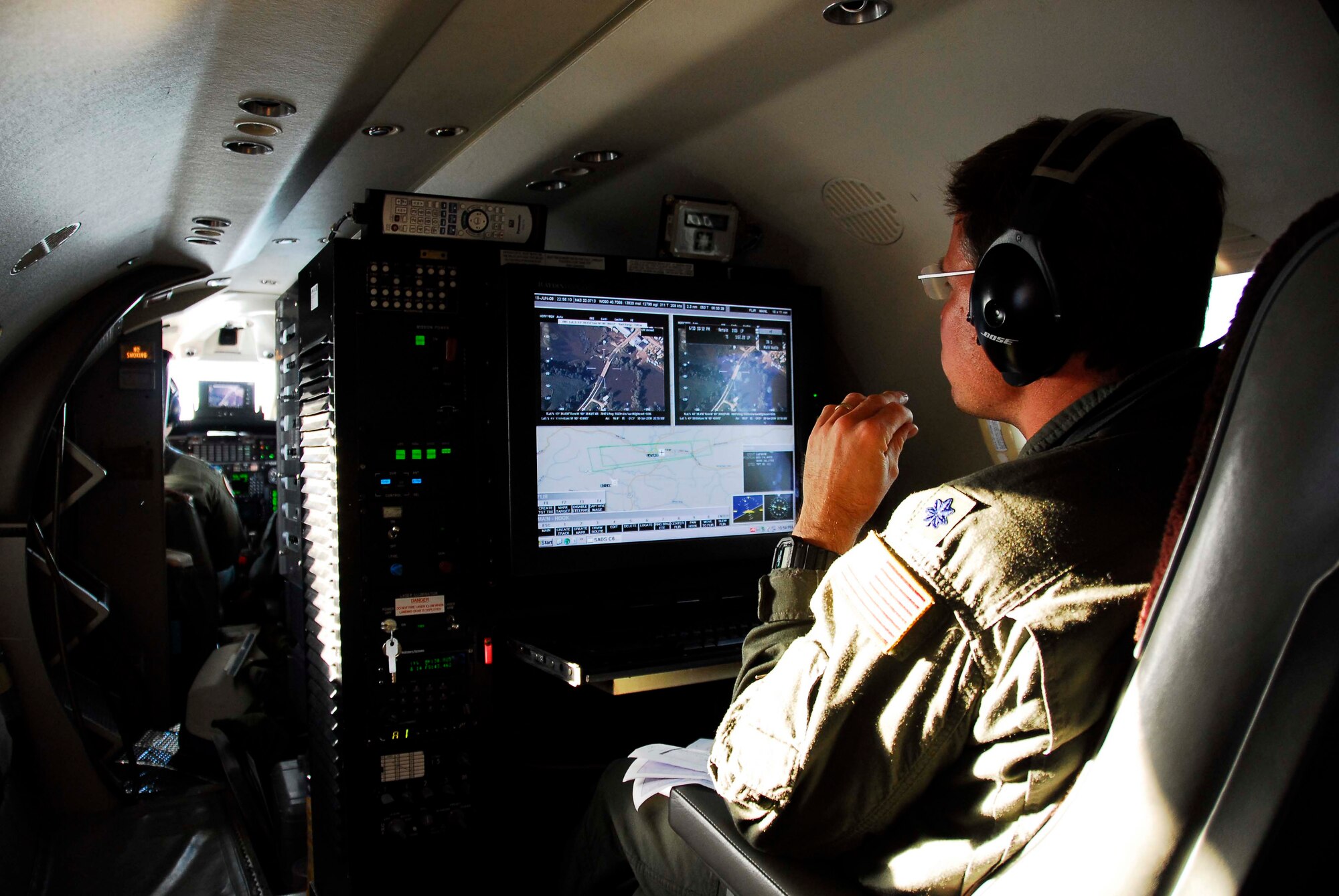 Mission system operator Lt Col Tim Howell from the 186th Air Refueling Wing, Meridian, MS operates a console aboard an RC-26 aircraft specifically designed for viewing and transmitting high quality video and still imagery to military and civilian Operations Centers in real-time.  This capability gives military commanders and civilian first responders a bird's eye view of significant events as they happen.  Working with several state agencies along with the Wisconsin Air National Guard, the Mississippi Air National Guard RC-26 demonstrated the benefits of this new capability during an initial flood assessment mission in southern Wisconsin on June 10th, 2008.  The crew of this RC-26 flew above the flood stricken region transmitting real-time imagery to the Wisconsin Joint Operations Center (JOC) and the Wisconsin Emergency Operations Center (WEOC) in addition to other agencies.  This imagery was used to asses the integrity of several area Dams in addition to flood damage assessment in the hardest hit regions of the southern half of the state.