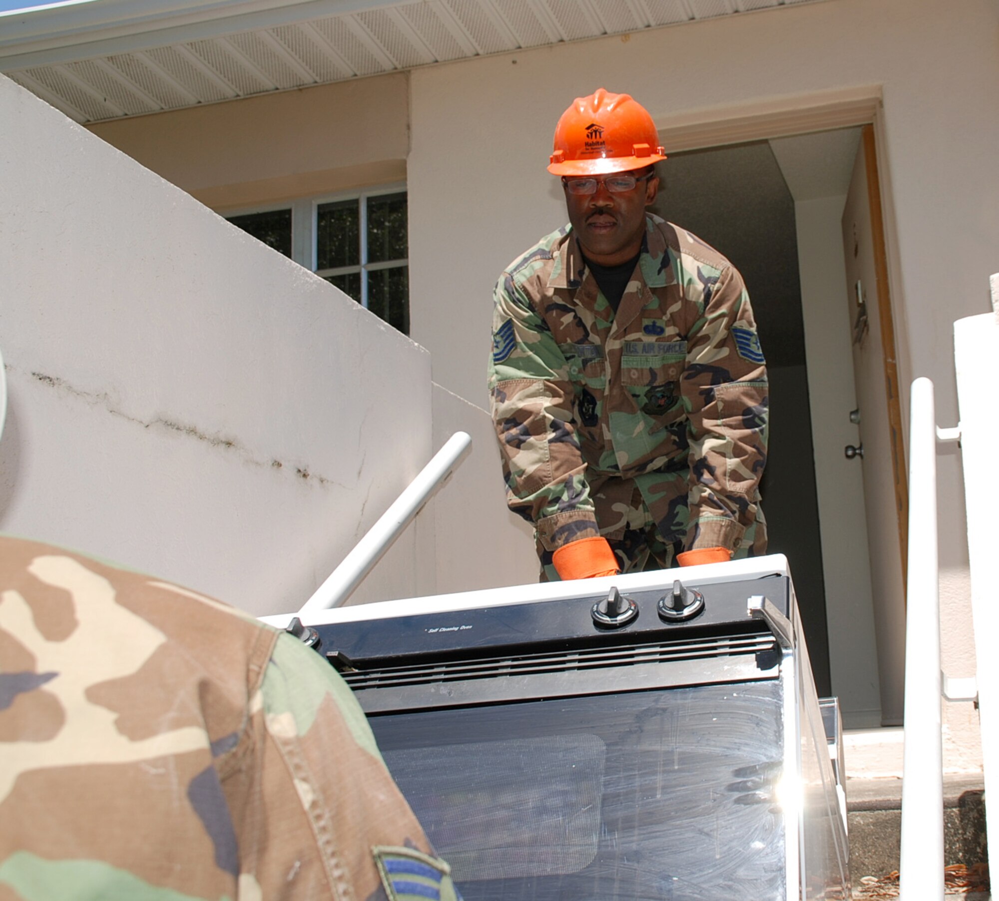Tech. Sgt. Eddie Norton, who volunteered to work with Habitat for Humanity during a deployment to MacDill Air Force Base, Fla., removes a stove that will be sent to the community service group, which builds houses for those in need.  Sergeant Norton is a member of the 442nd Services Flight, part of the 442nd Fighter Wing, an Air Force Reserve unit based at Whiteman AFB, Mo.  (U.S. Air Force photo/Tech. Sgt. Susan Walthour)