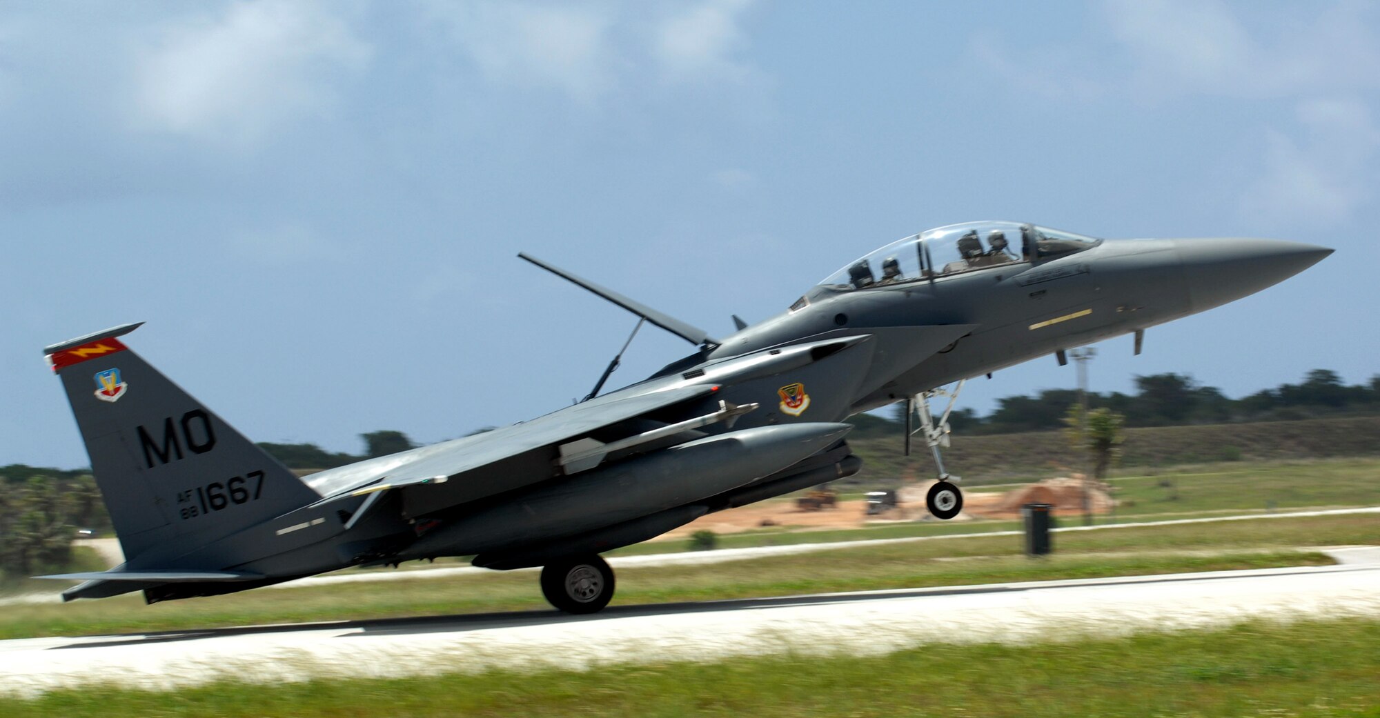An F-15E Strike Eagle touches down on the flightline June 4 at Andersen Air Force Base, Guam. A total of 12 F-15s deployed from Mountain Home Air Force Base, Idaho, for a four-month tour to Andersen AFB. Flying in the Pacific region will allow the unit a chance to train in maritime interdiction missions. (U.S. Air Force/Airman 1st Class Cory Todd)
