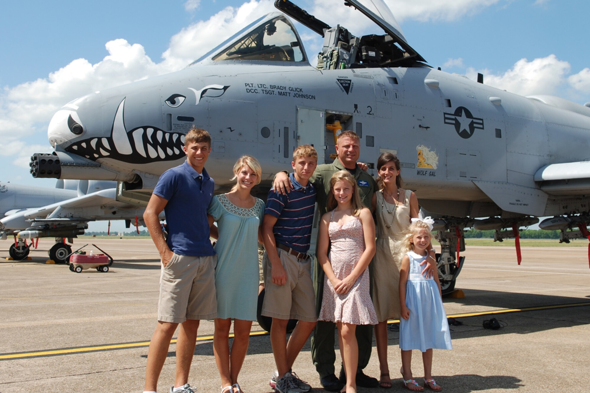Lt Col Brady Glick, 47th Fighter Squadron pilot, poses with his family following his return from a record setting sortie in the A-10 Thunderbolt II. Lt Col Glick set the all-time single total flying hours record in the A-10 with 4,666 flying hours and 2,495 sorties on June 13, 2008, 917th Wing, Barksdale AFB, La. (U.S. Air Force photo by Master Sgt. Gregory W. Steele/Released)