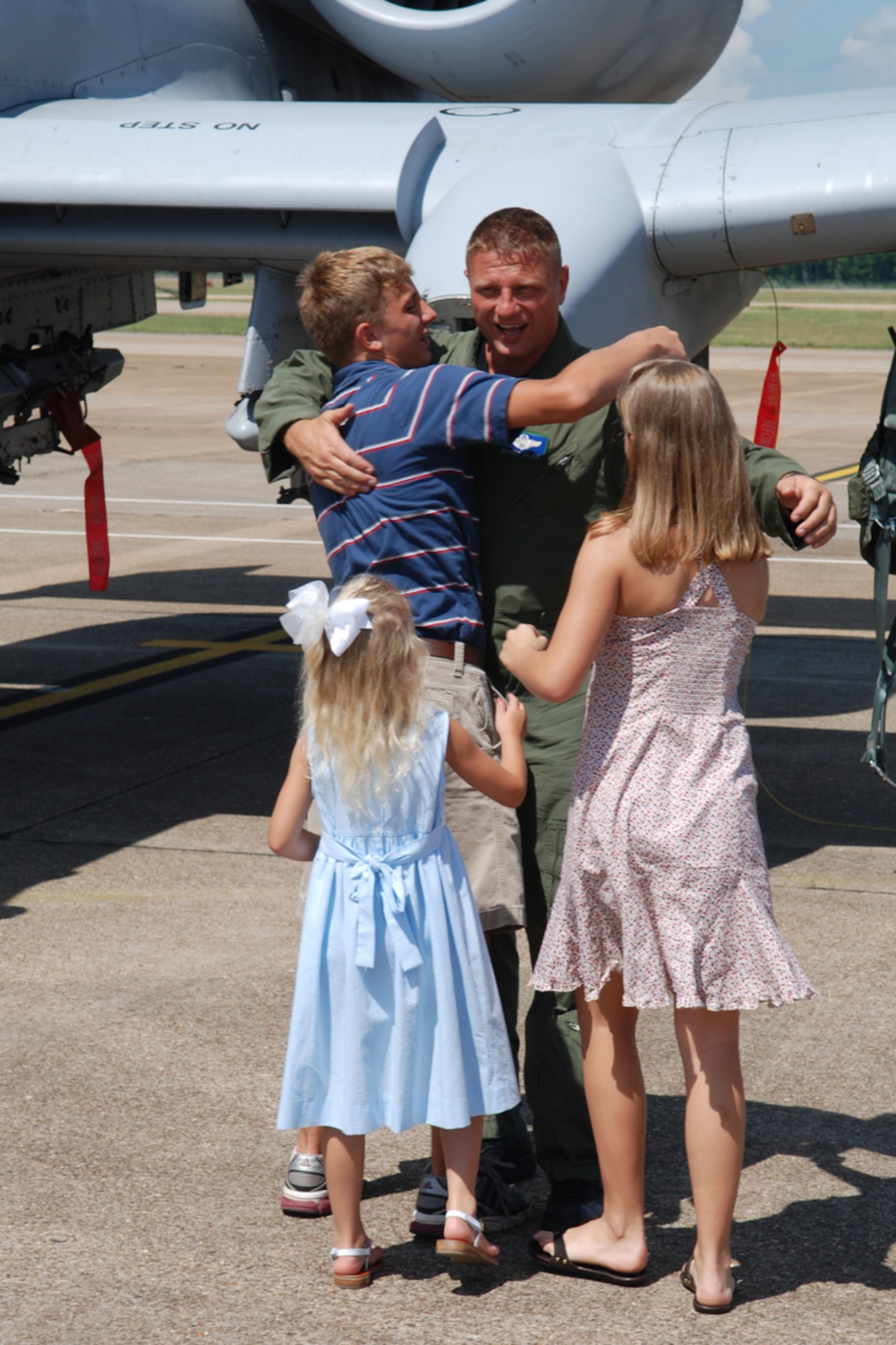 Lt Col Brady Glick, 47th Fighter Squadron pilot, is greeted by his family after returning from a record setting sortie in the A-10 Thunderbolt II. Lt Col Glick set the all-time single total flying hours record in the A-10 with 4,666 flying hours and 2,495 sorties on June 13, 2008, 917th Wing, Barksdale AFB, La. (U.S. Air Force photo by Master Sgt. Gregory W. Steele/Released)