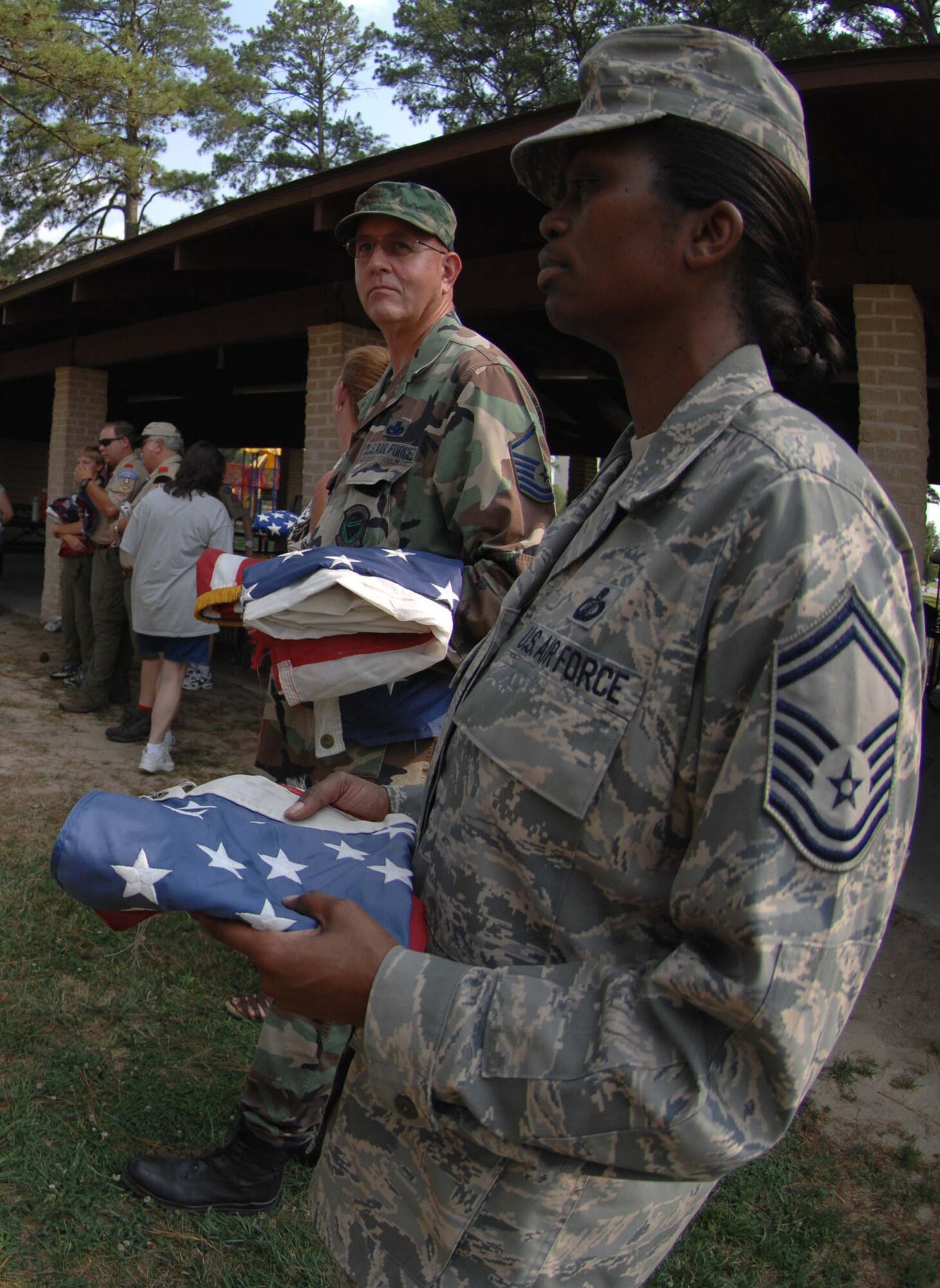 SEYMOUR JOHNSON AIR FORCE BASE, N.C. Senior Master Sgt. Juanita Osby and Master Sgt. David Parker wait in line to retire their American flags during a flag retirement ceremony, June 14 2008. (U.S. Air Force photo by Airman 1st Class Gino Reyes)