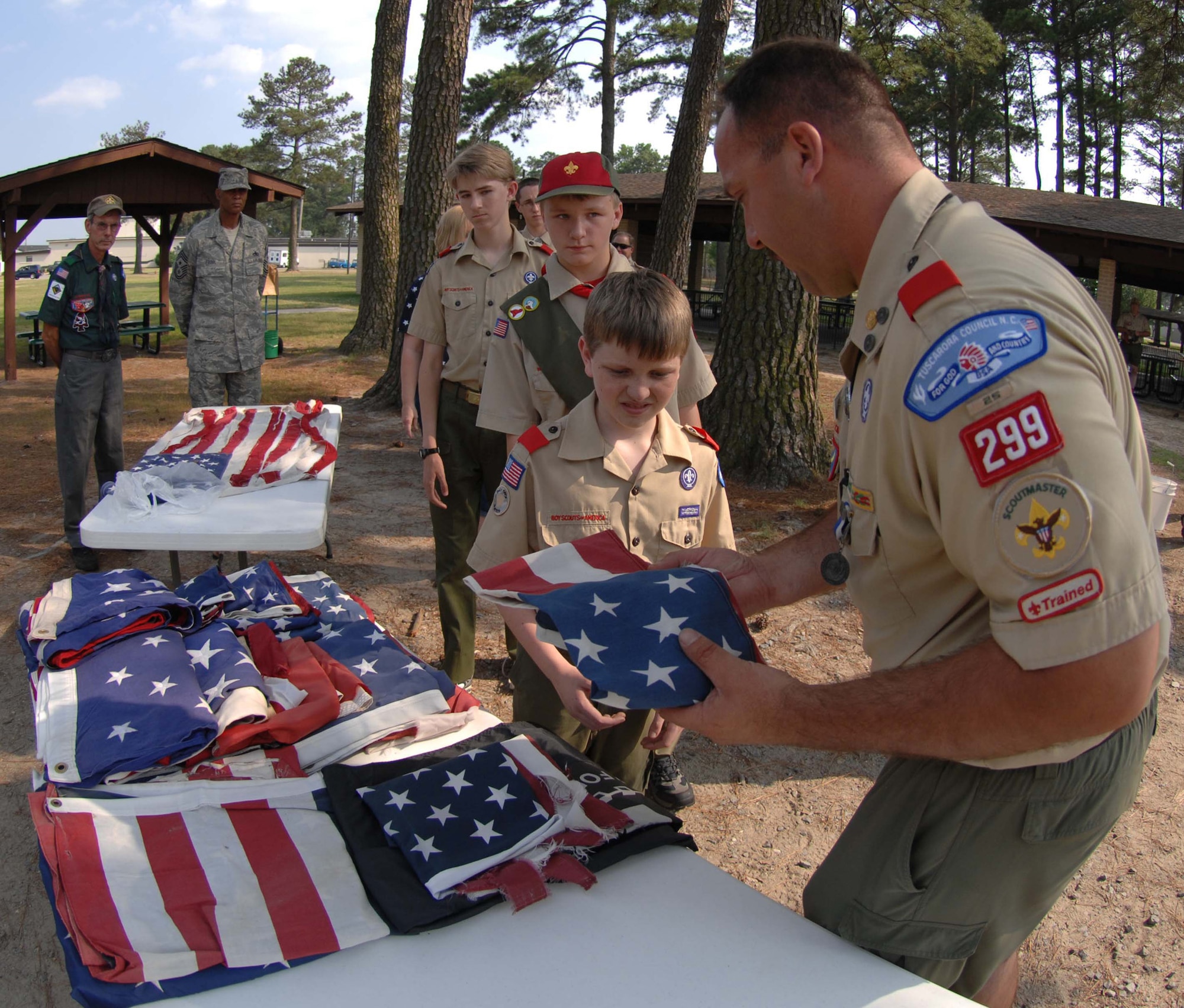 SEYMOUR JOHNSON AIR FORCE BASE, N.C. Leader of the Troop 299 passes out American flags to his troop for a flag retirement ceremony, June 14 2008. (U.S. Air Force photo by Airman 1st Class Gino Reyes)