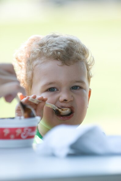 Brennan Klingenberg, son of Captain Mathew Klingenberg, 3rd Airlift Squadron, enjoys his ice cream during the Wing Picnic June 13.  The Central Delaware Chamber of Commerce donated and served the ice cream to Team Dover members in recognition for Dover Air Force Base’s support of the local community.  (U.S. Air Force Photo by Roland Balik)