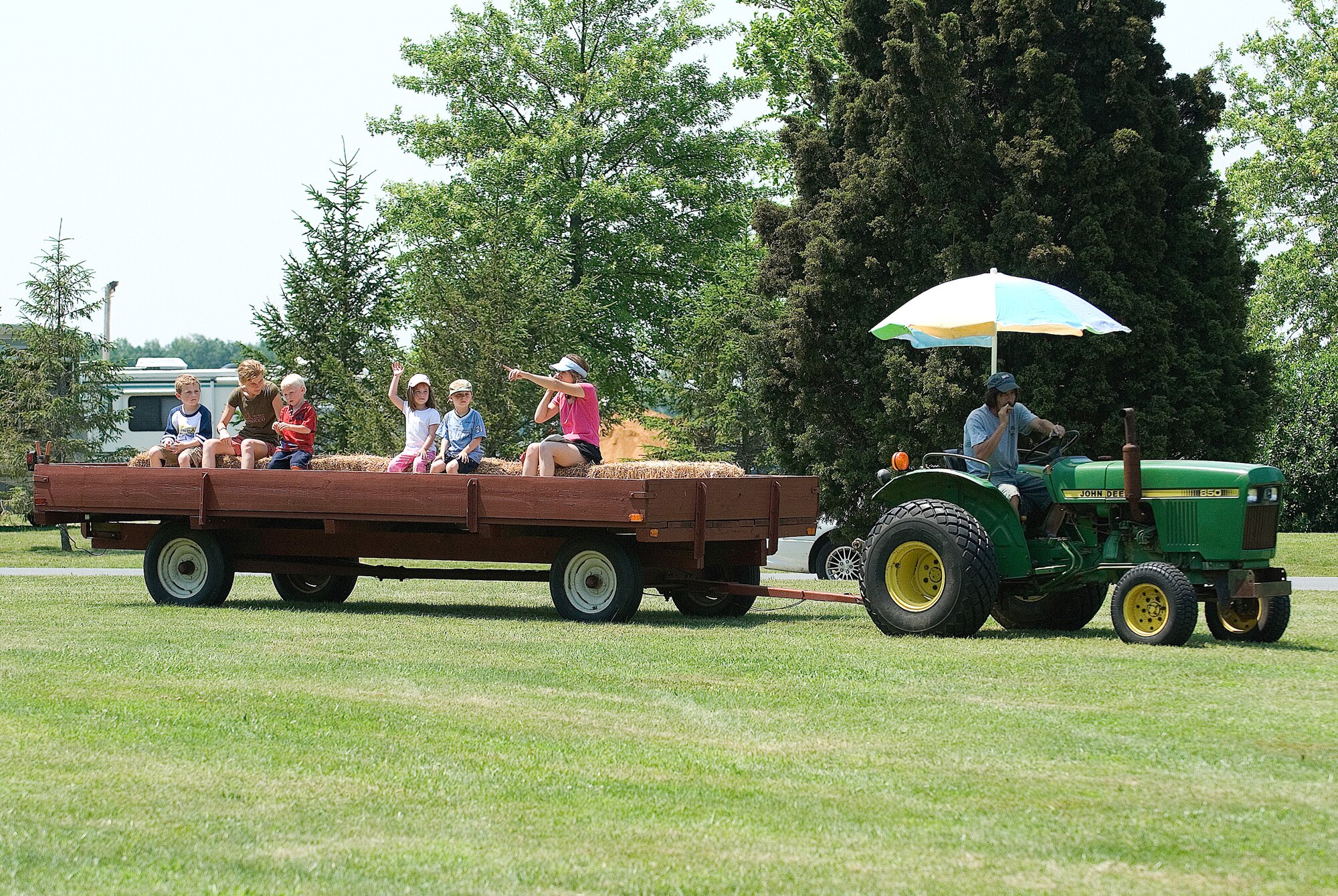 Team Dover family members enjoy a hay ride during the Wing Picnic June 13 at the Eagles Nest Picnic Area.  (U.S. Air Force Photo by Roland Balik)