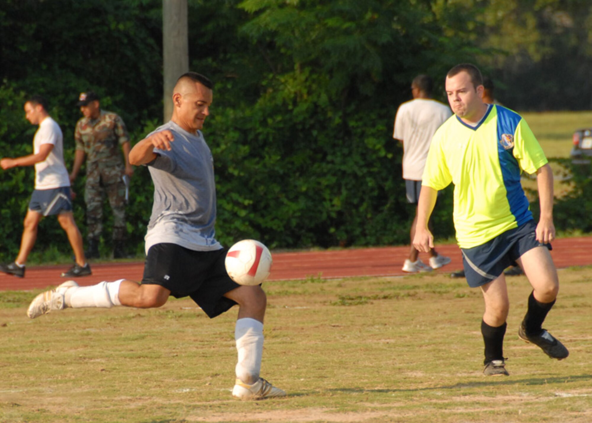Staff Sgt. Danny Rodriguez, 16th Electronic Warfare Squadron, takes a shot at the goal as Senior Airman Edward Verstraete, 68th Electronic Warfare Squadron, attempts to block during a soccer match June 17 at Eglin Air Force Base, Fla.  The two squadrons are perennial rivals and are constantly competing for the top spot in 53d and Electronic Warfare Group morale and sporting events.  The game came down to a goal kick by the 68th for the win.  The score was 1-0.  Photo by Staff Sgt. Samuel King Jr.