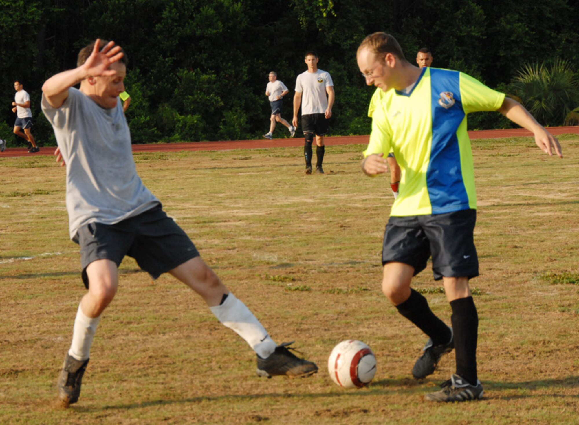 Col Steve DePalmer, 53d Wing commander, but playing for the 16th Electronic Warfare Squadron, attempts to steal the ball from Staff Sgt. Richard Todd, 68th Electronic Warfare Squadron, during a soccer match June 17 at Eglin Air Force Base, Fla.  The two squadrons are perennial rivals and are constantly competing for the top spot in 53d and Electronic Warfare Group morale and sporting events.  The game came down to a goal kick by the 68th for the win.  The score was 1-0.  Photo by Staff Sgt. Samuel King Jr.