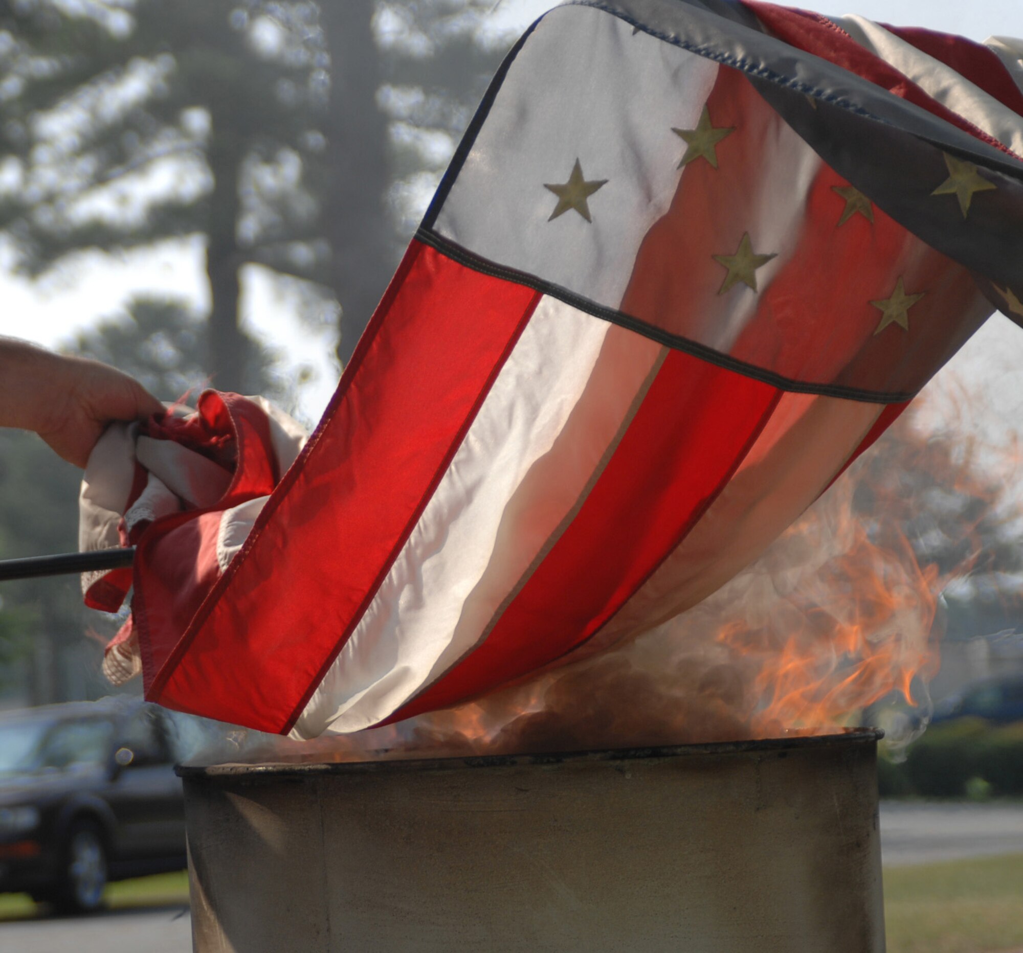 SEYMOUR JOHNSON AIR FORCE BASE, N.C. - Members from Boy Scout Troop 299 place an American flag in a barrel of flames, June 14, 2008. This was part of a flag retirement ceremony, which shows respect to worn, faded U.S. flags. (U.S. Air Force photo by Airman 1st Class Makenzie R. Lang)