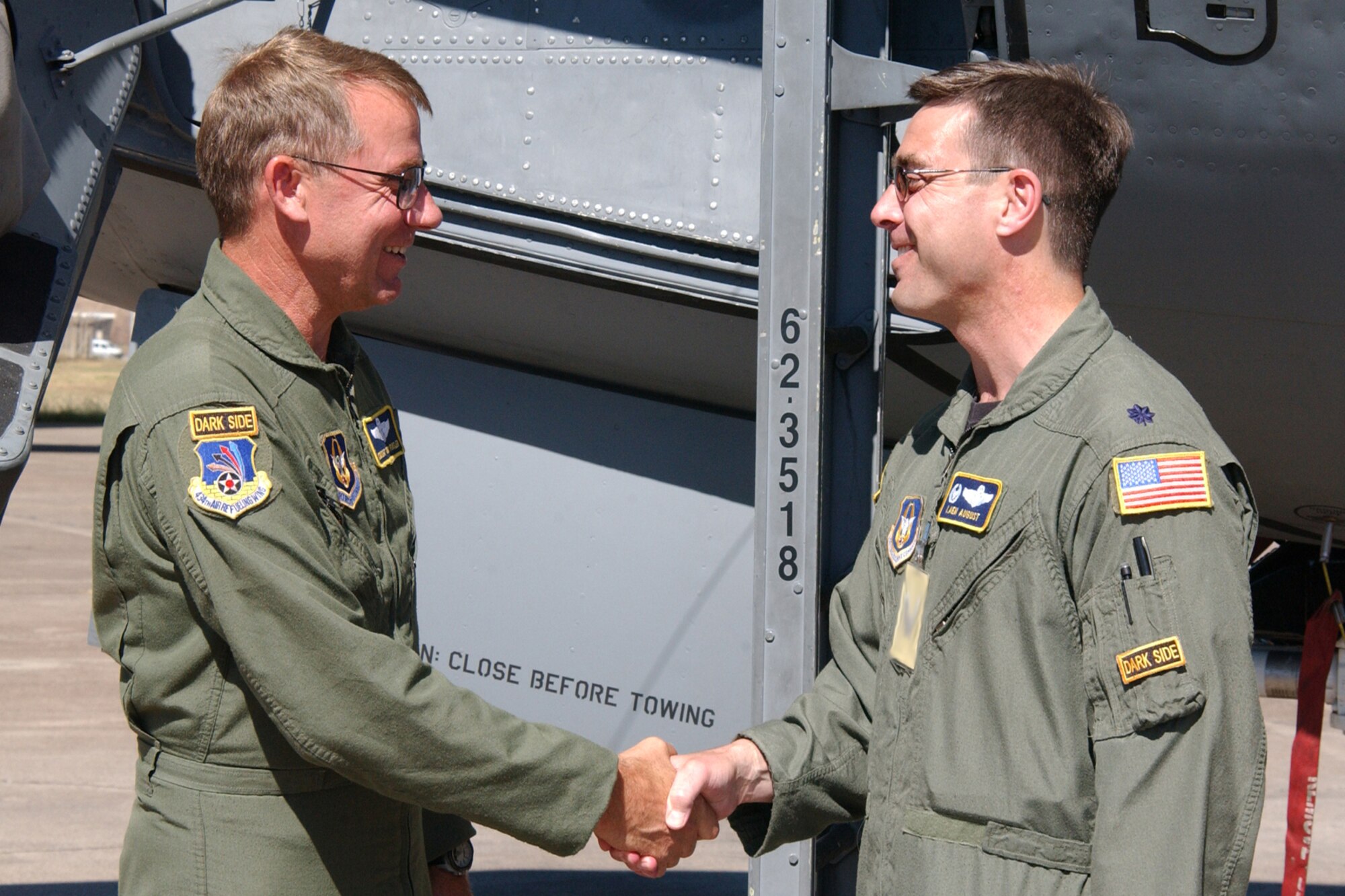 INCIRLIK AB, TURKEY  --  Lt. Col. Laen August, 90th Expeditionary Air Refueling Squadron commander, and 72nd Air Refueling Squadron commander, congratulates Chief Master Sgt. Tony Fansler, 90 EARS, after completing more than 10,000 hours of flying time June 19. Chief Fansler is a boom operator with the 72nd Air Refueling Squadron back at Grissom. (U.S. Air Force photo/Airman 1st Class Benjamin Wilson)