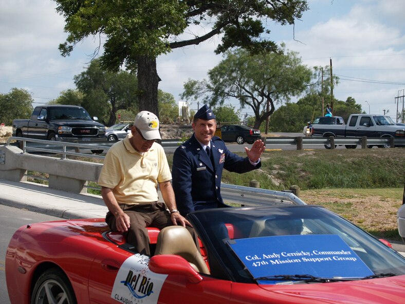 LAUGHLIN AIR FORCE BASE, Texas -- Col. Andy Cernicky, 47th Mission Support Group commander, waves to the crowd during the Annual Juneteenth parade through the streets of Del Rio. Riding with the colonel is Del Rio Councilman Claudio Sotello. Juneteenth celebrates the news of the Emancipation Proclamation reaching Texas June 19, 1865,  freeing the slaves. On January 1, 1980, Juneteenth became an official Texas state holiday. (U.S. Air Force photo by Ron Scharven) 
