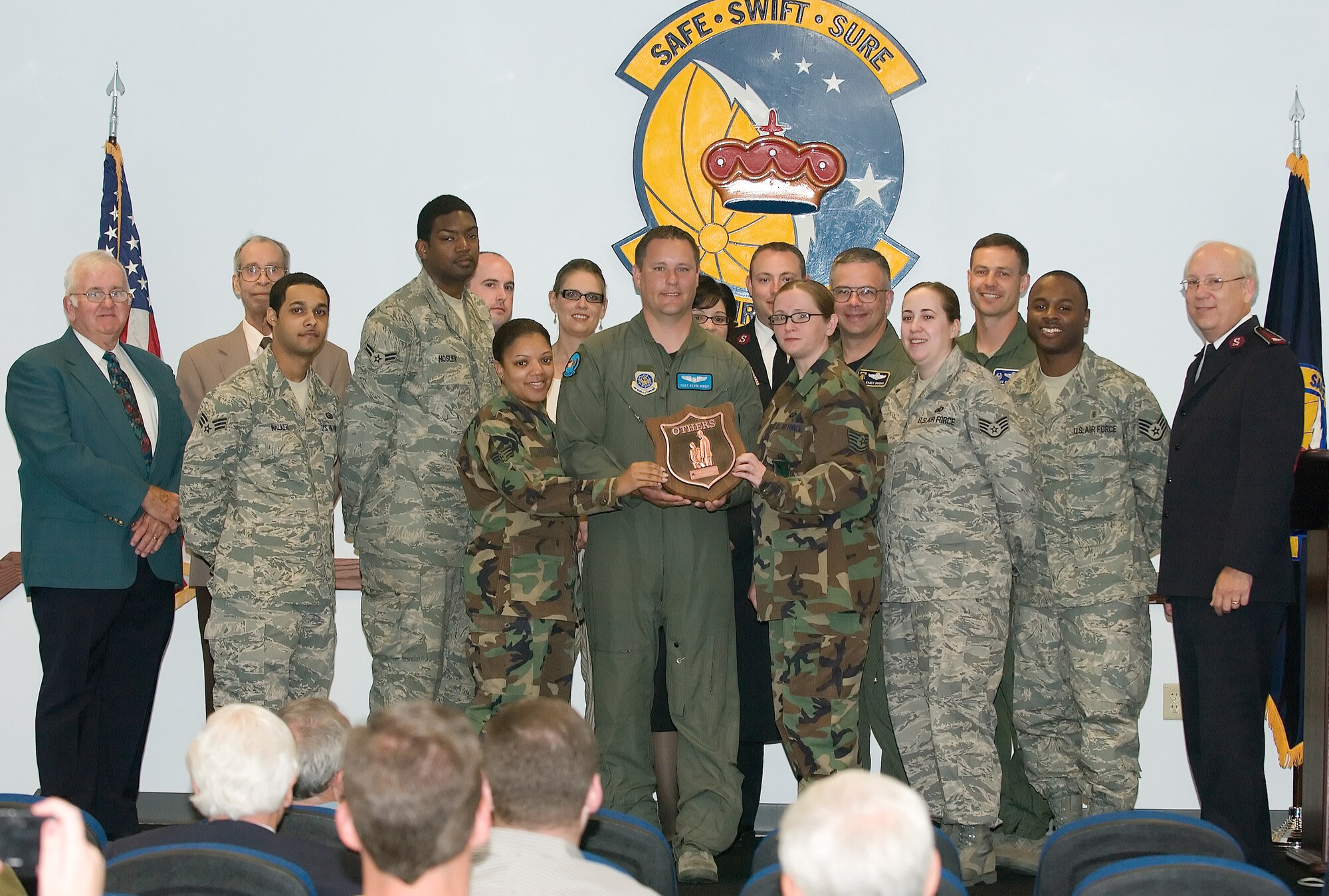 A group representing Dover volunteers accept the Others Award from Salvation Army representatives June 4 at the base.  The Salvation Army bestowed the award upon Team Dover in recognition for more than 165 volunteers who donated their time to the organization's efforts during the 2007 holiday season.  (U.S. Air Force Photo by Jason Minto)