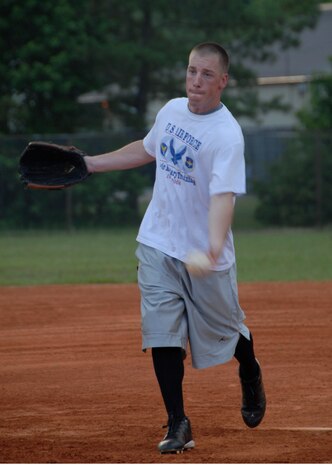 Casey Cousins goes for another striking pitch against the 437th Security Forces Squadron softball team June 17. Cousins is the pitcher for the 437th Communications Squadron softball team. (U.S. Air Force photo/Airman 1st Class Cynthia Spalding) 