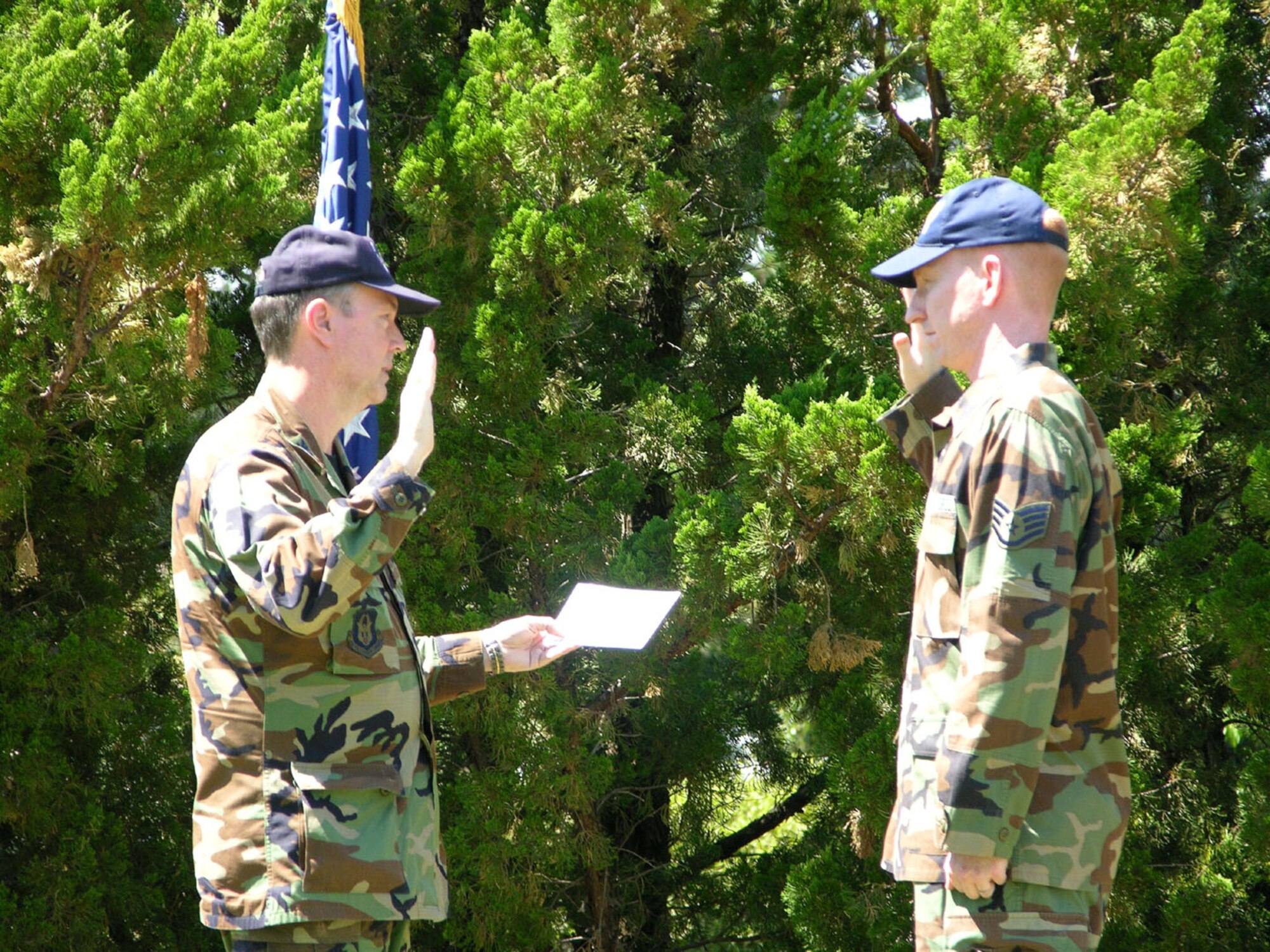 SEYMOUR JOHNSON AIR FORCE BASE, N.C. -- Staff. Sgt. Charles Alford (right) takes the re-enlistment oath outside on a beautiful North Carolina day. Administrating the oath is Col. Woody Woodson, 916th Mission Support Group commander. Sergeant Alford is a Reservist with the 916th Communications Squadron and works as a computer maintenance apprentice. U.S. Air Force photo/Ms. Donna Lea