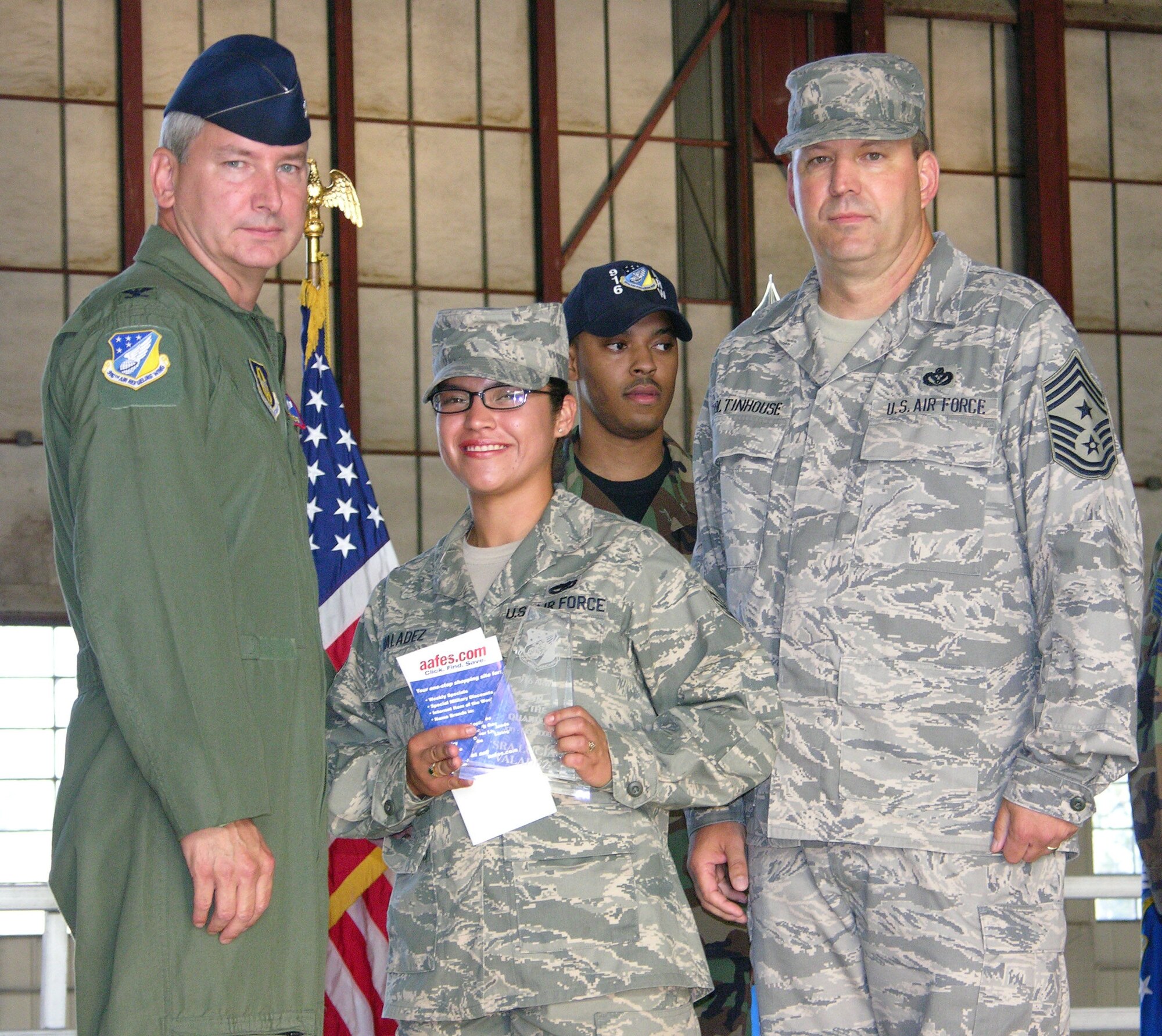 SEYMOUR JOHNSON AIR FORCE BASE, N.C. -- Senior Airman Lucia Valadez (center) receives the 916th Airman of the Quarter award for January-March from Col. Fritz Linsenmeyer (left), 916th Air Refueling Wing commander and Command Chief Master Sgt. Lester Boltinhouse. Airman Valadez is a Reservist with the 916th Civil Engineer Squadron and works as a operation management craftsman. U.S. Air Force photo/TSgt. Scotty Sweatt