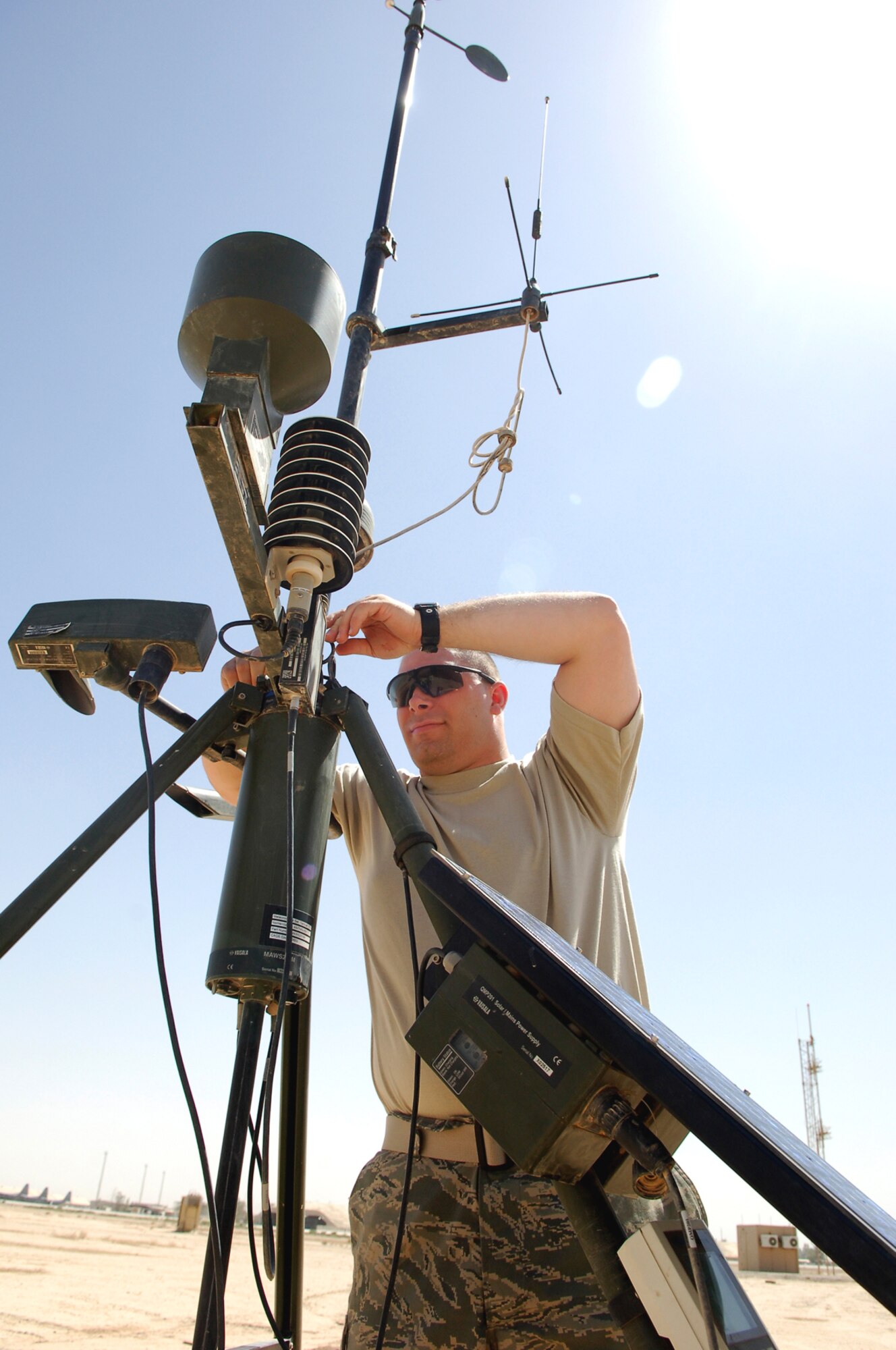 JOINT BASE BALAD, Iraq -- Staff Sgt. Richard Skelly, a 332nd Expeditionary Operations Support Squadron combat weather forecaster, cleans components of the TMQ-53 here, June 14. The TMQ-53 is a suite of tactical weather equipment used to measure weather variables, including cloud height, wind speed and direction, humidity, dew point and atmospheric pressure. Combat weather forecasters here also use a human observer in the air traffic control tower to monitor weather conditions on the airfield. Sergeant Skelly is deployed from Andrews Air Force Base, Md. (U.S. Air Force photo /Staff Sgt. Mareshah Haynes)
