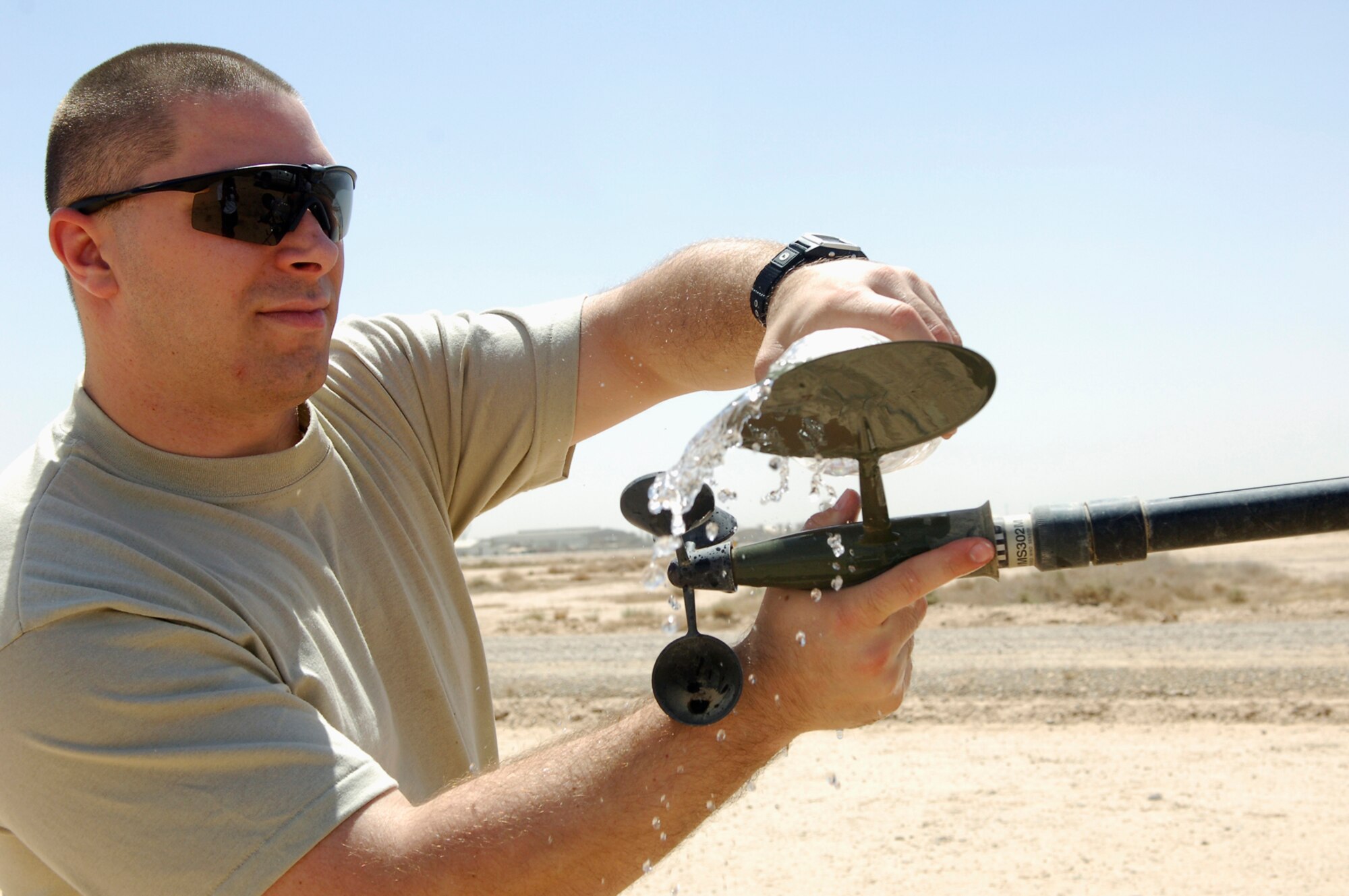 JOINT BASE BALAD, Iraq -- Staff Sgt. Richard Skelly, a 332nd Expeditionary Operations Support Squadron combat weather forecaster, cleans components of the tactical weather equipment suite that measure the wind speed and direction here, June 14. It's important for the forecasters to make sure the equipment is clean and functioning properly to get accurate weather readings on the airfield. Sergeant Skelly is deployed from Andrews Air Force Base, Md. (U.S. Air Force photo /Staff Sgt. Mareshah Haynes)