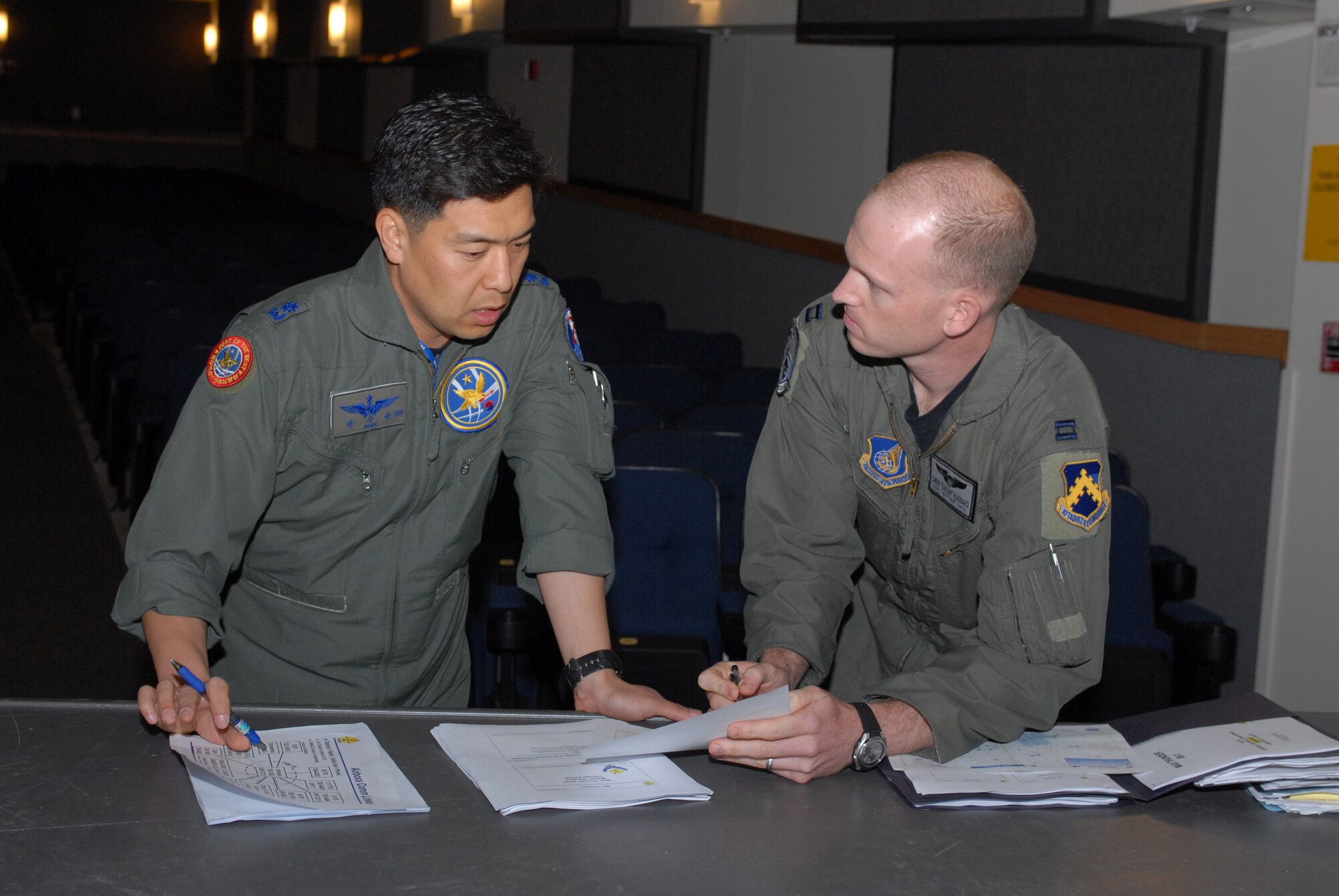 KUNSAN AIR BASE, Republic of Korea -- Republic of Korea Air Force Maj. Sang-Gyoon Park, a pilot with the 11th Fighter Wing, discusses the Max Thunder 08-01 itinerary with Capt. Chris Hubbard, 8th Operations Group, here June 16.  Max Thunder 08-01 is a bi-lateral training exercise between USAF and ROKAF airmen used to strengthen joint operations and sharpen war fighting skills.