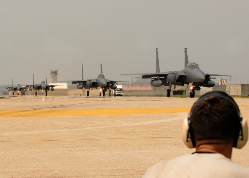 KUNSAN AIR BASE, Republic of Korea—Senior Airman Jorge Schweitzer, Assistant crew chief from the 35th Aircraft Maintenance Unit watches Republic of Korea Air Force F-15Ks taxi here June 19 during the Max Thunder exercise. Training side-by-side is part of day-to-day operations for ROKAF and USAF forces at Kunsan Air Base. The bi-lateral training received during Max Thunder will not only improve interoperability, but is also intended to assist the ROKAF prepare for RED FLAG Nellis in August 2008. (U.S. Air Force Photo/Staff Sgt Araceli Alarcon)
