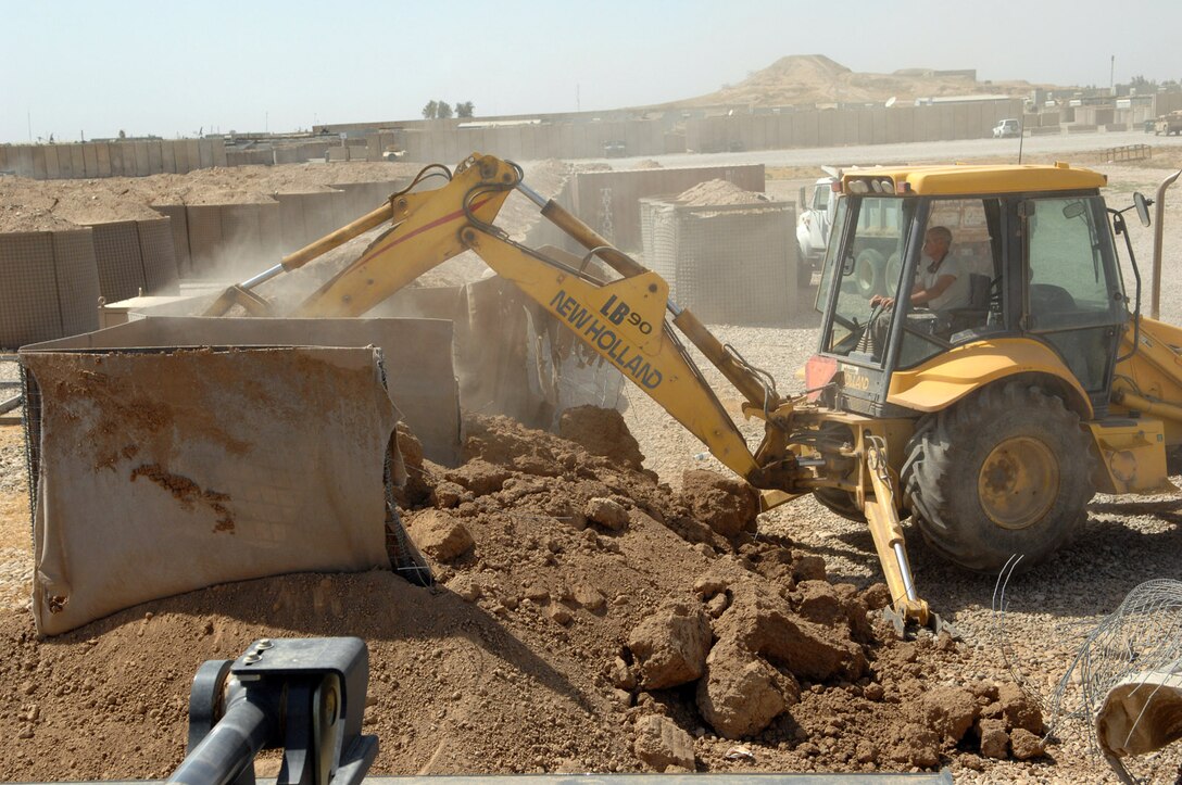 KIRKUK REGIONAL AIR BASE, Iraq – Tech Sgt. Eric Stoltz, 506th Expeditionary Civil Engineer Squadron, removes barriers to prepare for future construction projects June 10 here. Sergeant Stoltz is deployed here from Pittsburgh International Air Reserve Station, Pa., and is a native of Pittsburgh. (U.S. Air Force photo by Senior Airman SerMae Lampkin)