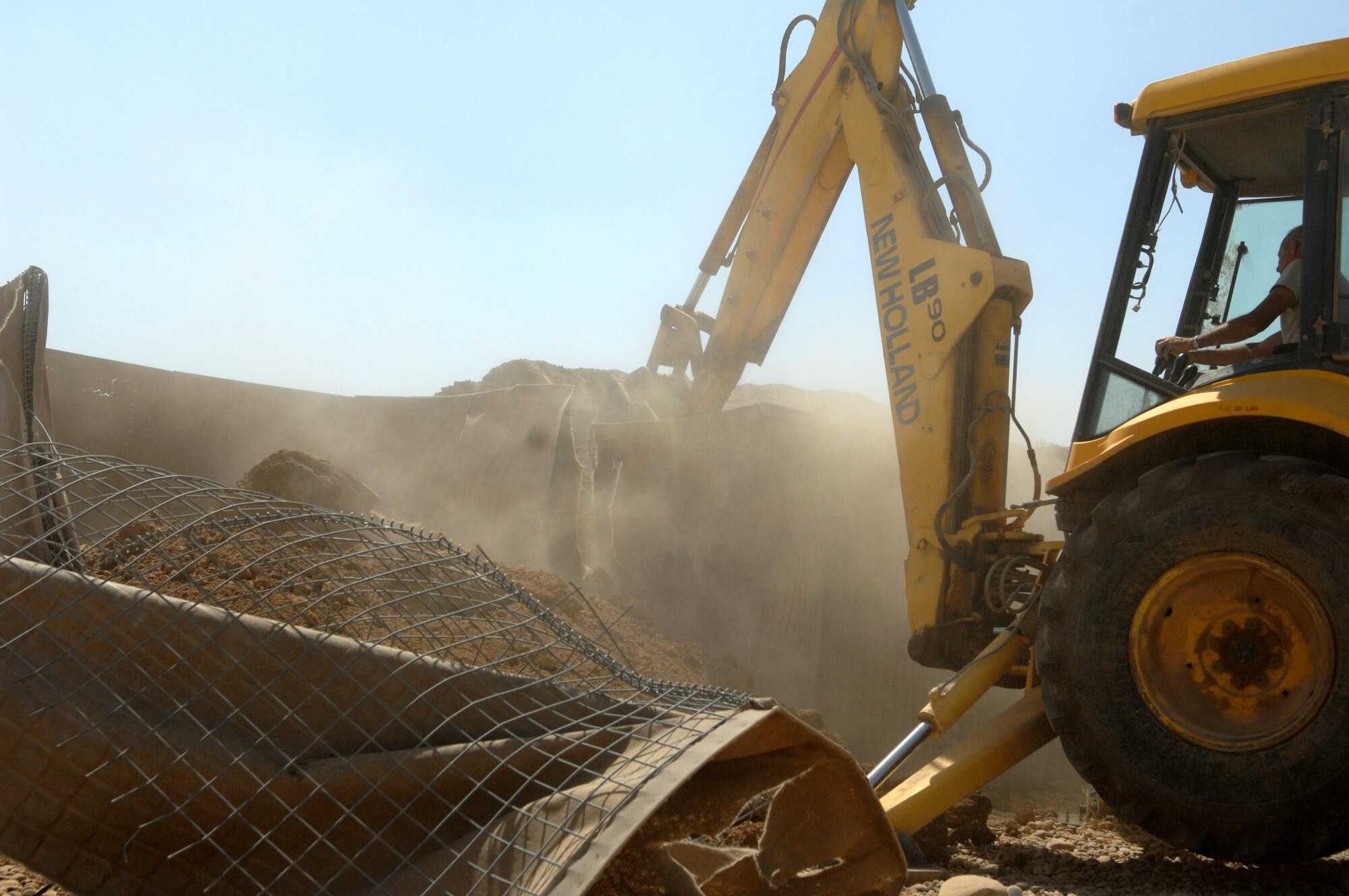 KIRKUK REGIONAL AIR BASE, Iraq – Tech Sgt. Eric Stoltz, 506th Expeditionary Civil Engineer Squadron, removes barriers to prepare for future construction projects June 10 here. Sergeant Stoltz is deployed here from Pittsburgh International Air Reserve Station, Pa., and is a native of Pittsburgh. (U.S. Air Force photo by Senior Airman SerMae Lampkin)